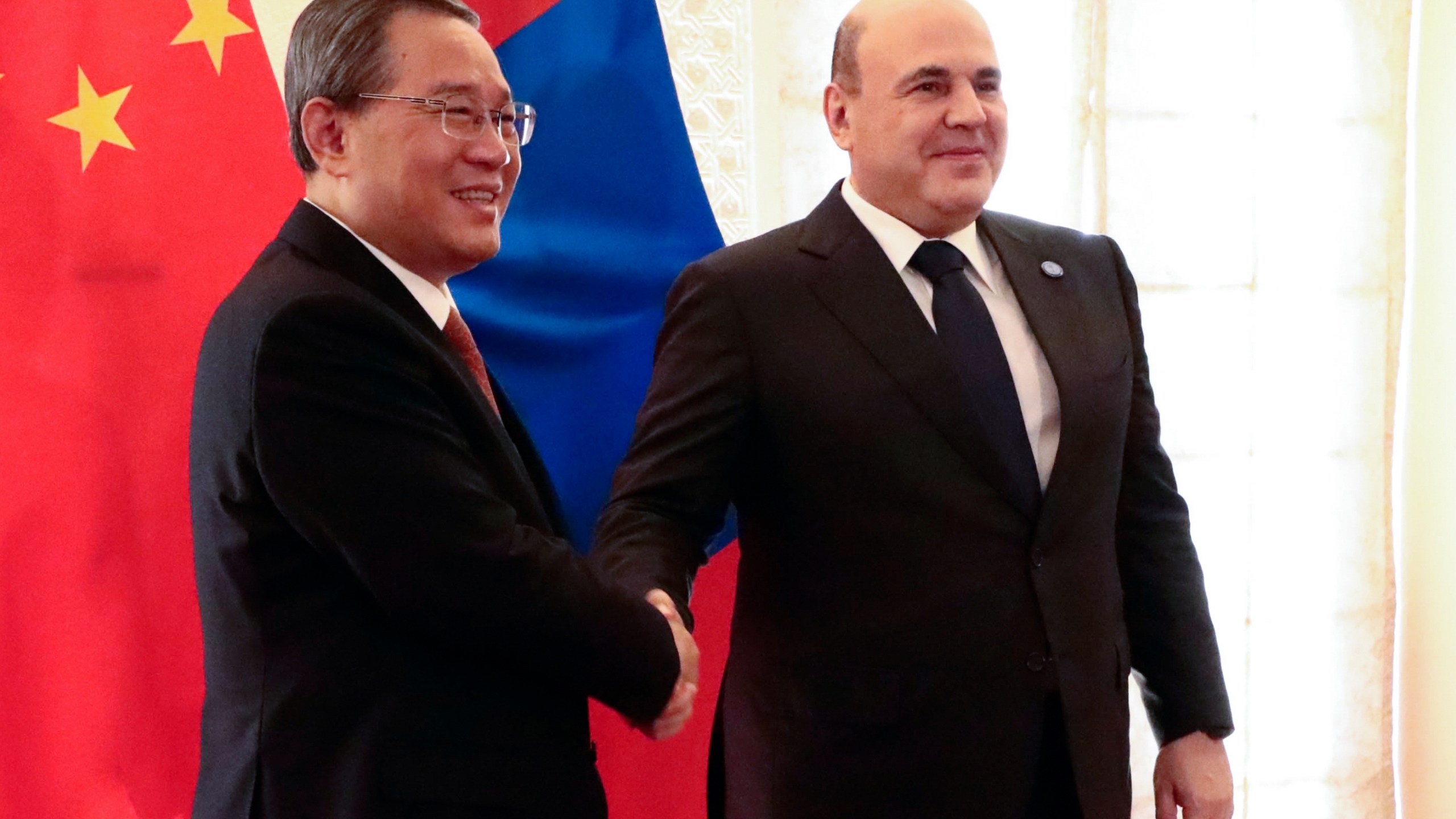 Chinese Premier Li Qiang, left, and Russian Prime Minister Mikhail Mishustin pose for a photo on the sidelines of the Shanghai Cooperation Organization (SCO) Council of Heads of Governments Summit in Islamabad, Pakistan, Wednesday, Oct. 16, 2024. (Alexander Miridonov, Sputnik, Government Pool Photo via AP)