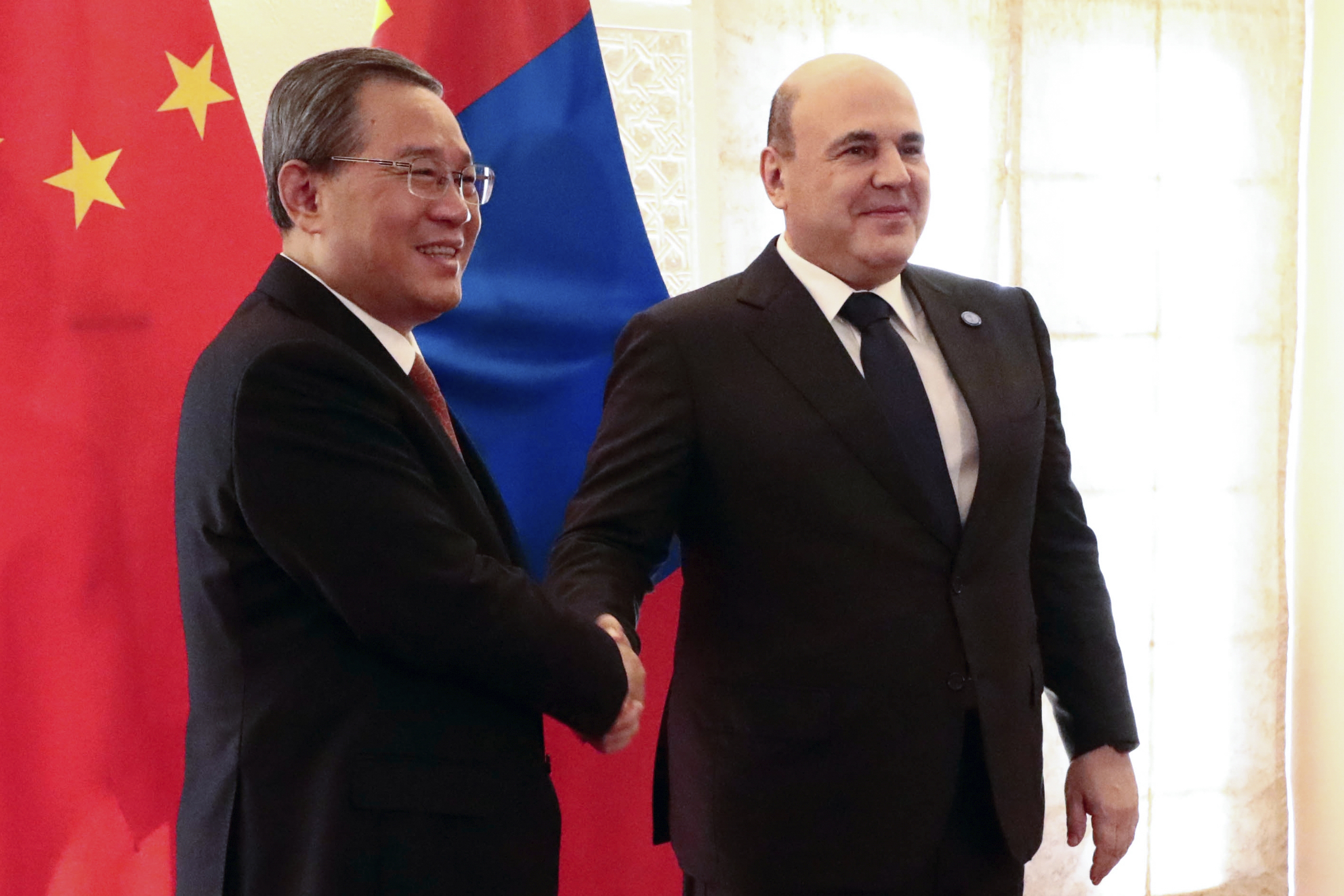 Chinese Premier Li Qiang, left, and Russian Prime Minister Mikhail Mishustin pose for a photo on the sidelines of the Shanghai Cooperation Organization (SCO) Council of Heads of Governments Summit in Islamabad, Pakistan, Wednesday, Oct. 16, 2024. (Alexander Miridonov, Sputnik, Government Pool Photo via AP)