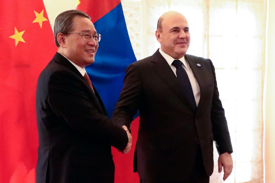 Chinese Premier Li Qiang, left, and Russian Prime Minister Mikhail Mishustin pose for a photo on the sidelines of the Shanghai Cooperation Organization (SCO) Council of Heads of Governments Summit in Islamabad, Pakistan, Wednesday, Oct. 16, 2024. (Alexander Miridonov, Sputnik, Government Pool Photo via AP)