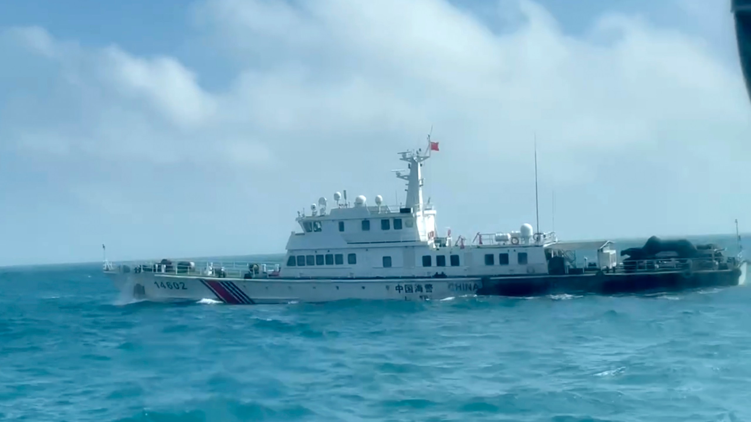 In this screen grab from video released by the Taiwan Coast Guard, a view of a China Coast Guard boat from a Taiwan Coast Guard boat as it passes near the coast of Matsu islands, Taiwan on Monday, Oct. 14, 2024. (Taiwan Coast Guard via AP)