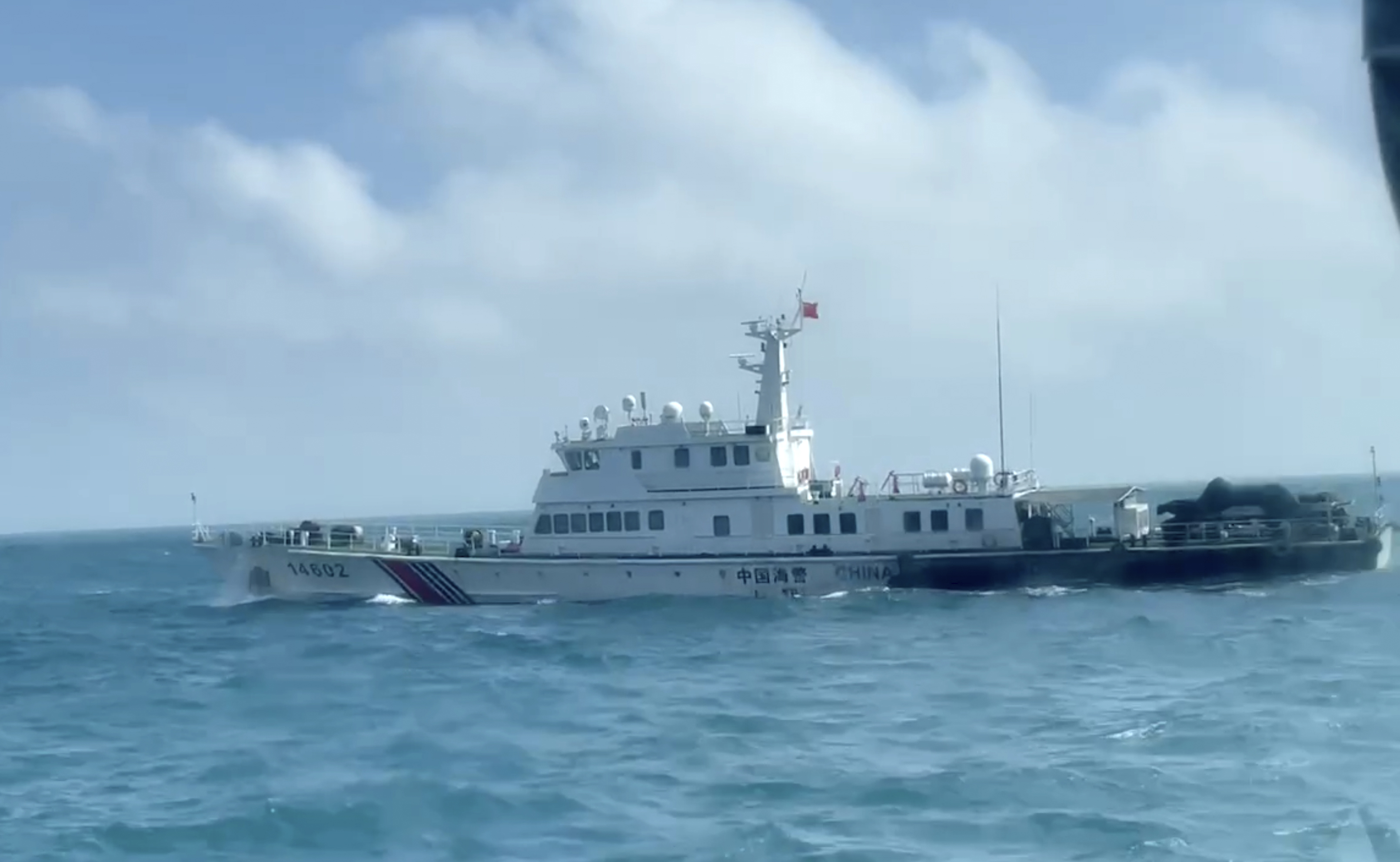 In this screen grab from video released by the Taiwan Coast Guard, a view of a China Coast Guard boat from a Taiwan Coast Guard boat as it passes near the coast of Matsu islands, Taiwan on Monday, Oct. 14, 2024. (Taiwan Coast Guard via AP)