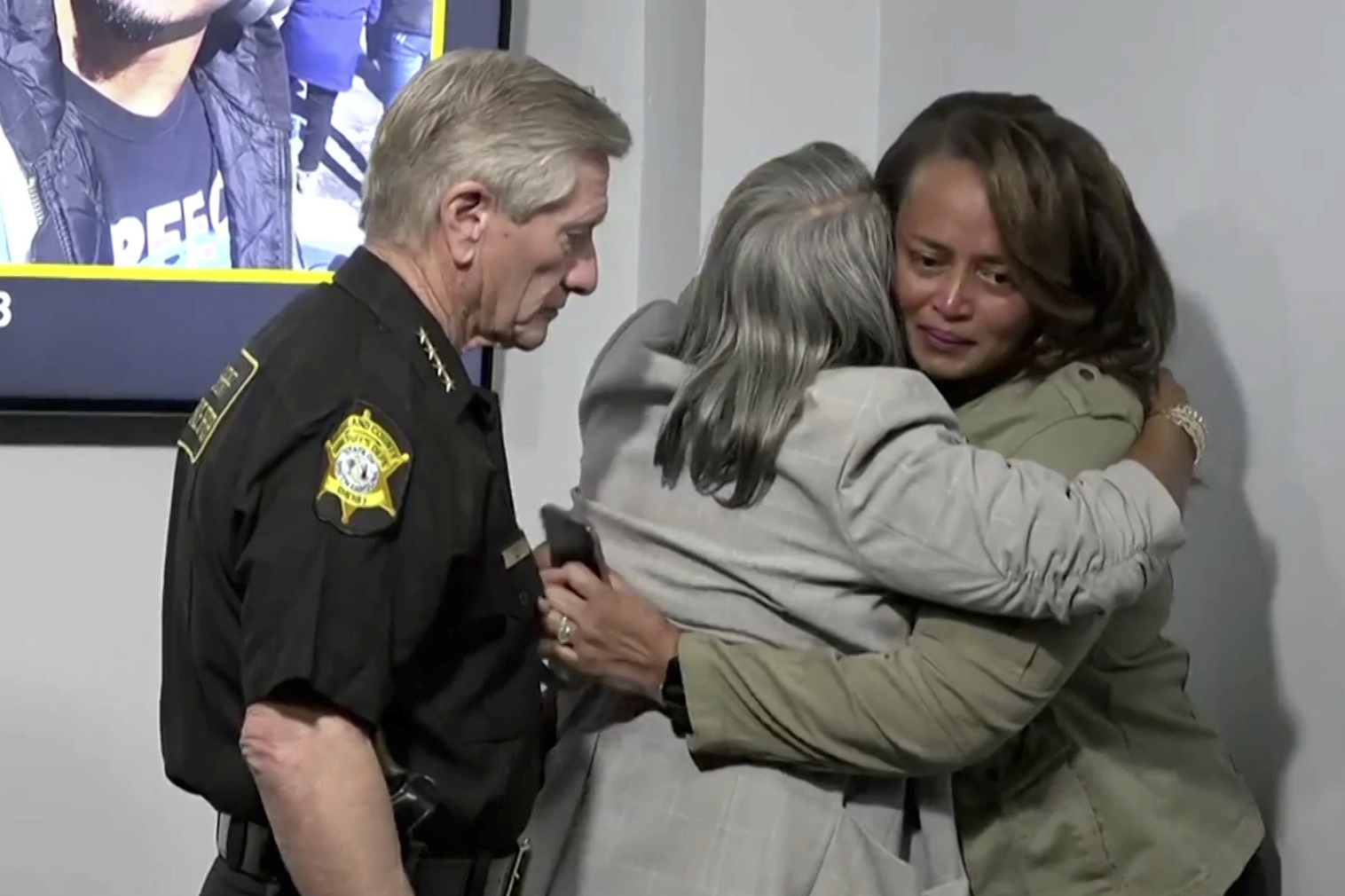 In this photo provided by Richland County Sheriff’s Office, Richland County Sheriff Leon Lott, left, stands next to Kathy Williams, middle, and Mieoki Corbett-Jacobs after discussing the search for 28-year-old Zelig Williams, a dancer who went missing on Oct. 3, after a news conference on Wednesday, Oct. 16, 2024 in Columbia, S.C. (Richland County Sheriff’s Office via AP)