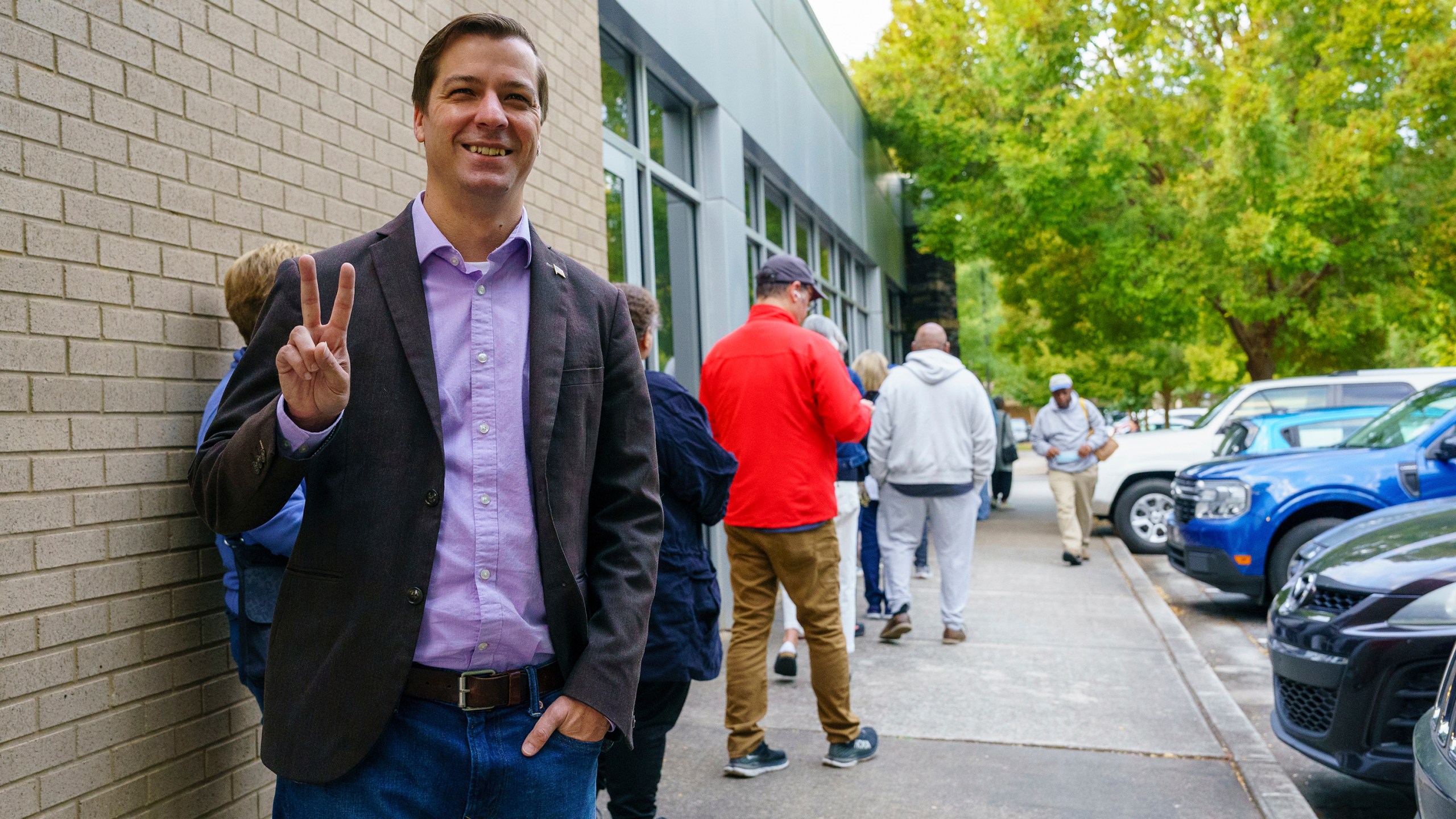 Libertarian Presidential Candidate Chase Oliver stands in line to vote at the Tucker-Reid H. Cofer branch of the Dekalb County Public Library on the first day of early voting, Tuesday, Oct. 15, 2024 in Tucker, Ga. (Matthew Pearson/WABE via AP)