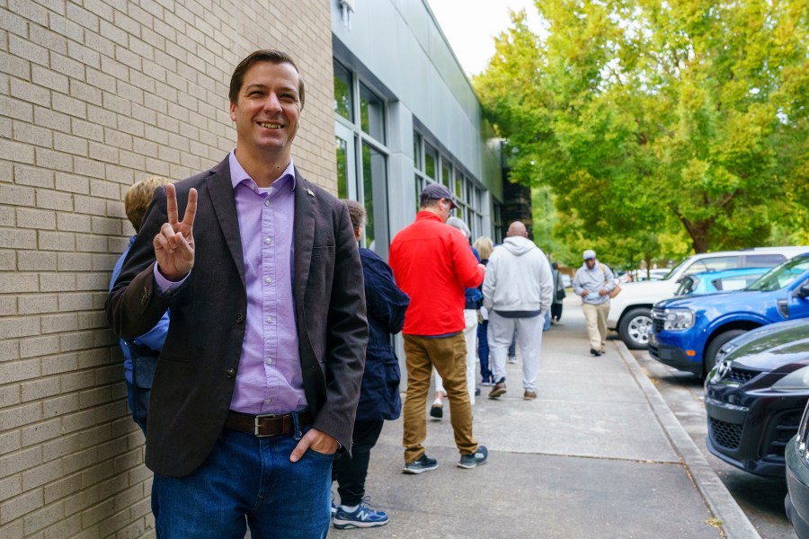 Libertarian Presidential Candidate Chase Oliver stands in line to vote at the Tucker-Reid H. Cofer branch of the Dekalb County Public Library on the first day of early voting, Tuesday, Oct. 15, 2024 in Tucker, Ga. (Matthew Pearson/WABE via AP)