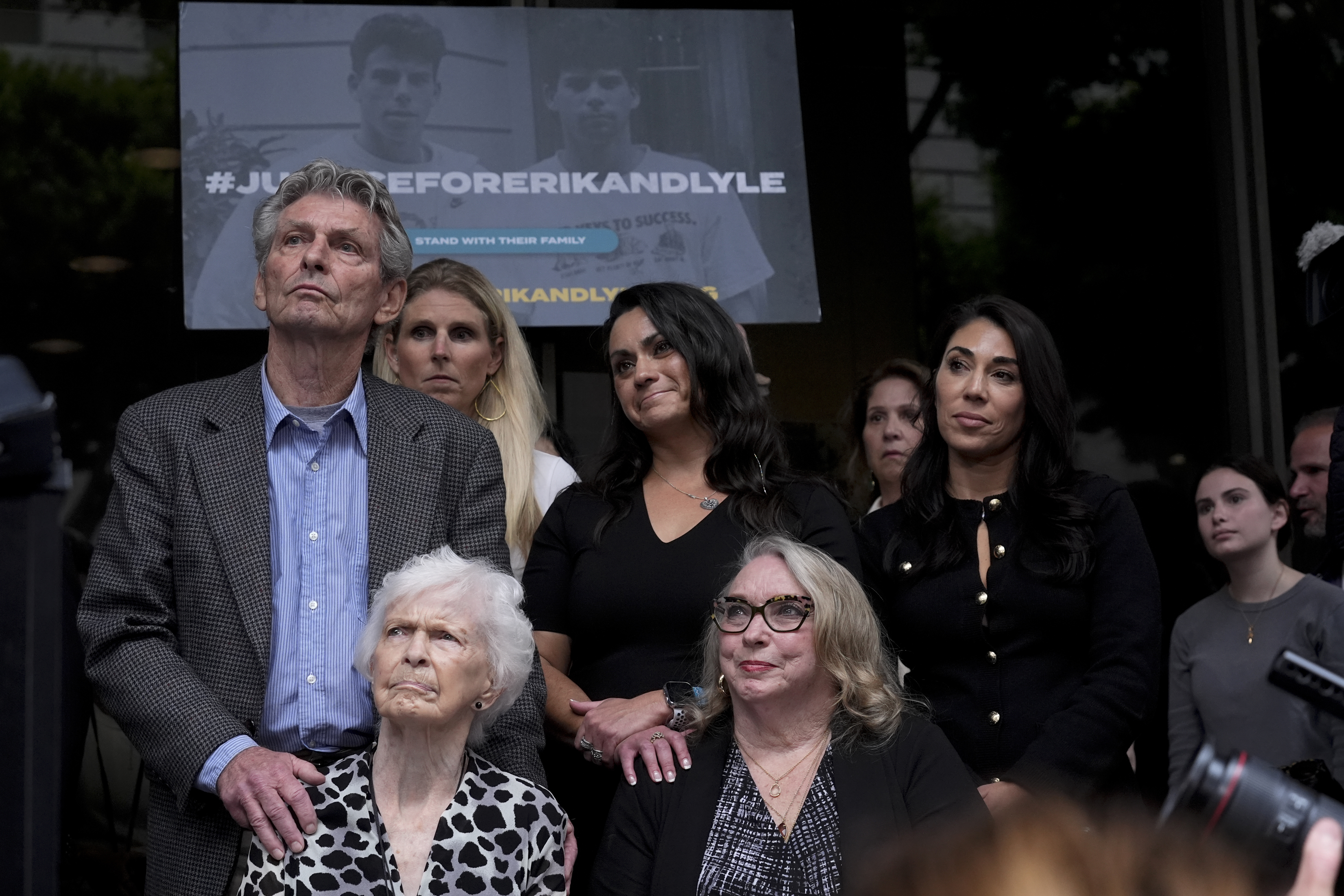 Kitty Menendez' sister, Joan Andersen VanderMolen, bottom left, and niece Karen VanderMolen, right, sit together during a press conference to announce developments on the case of brothers Erik and Lyle Menendez, Wednesday, Oct. 16, 2024, in Los Angeles. (AP Photo/Damian Dovarganes)