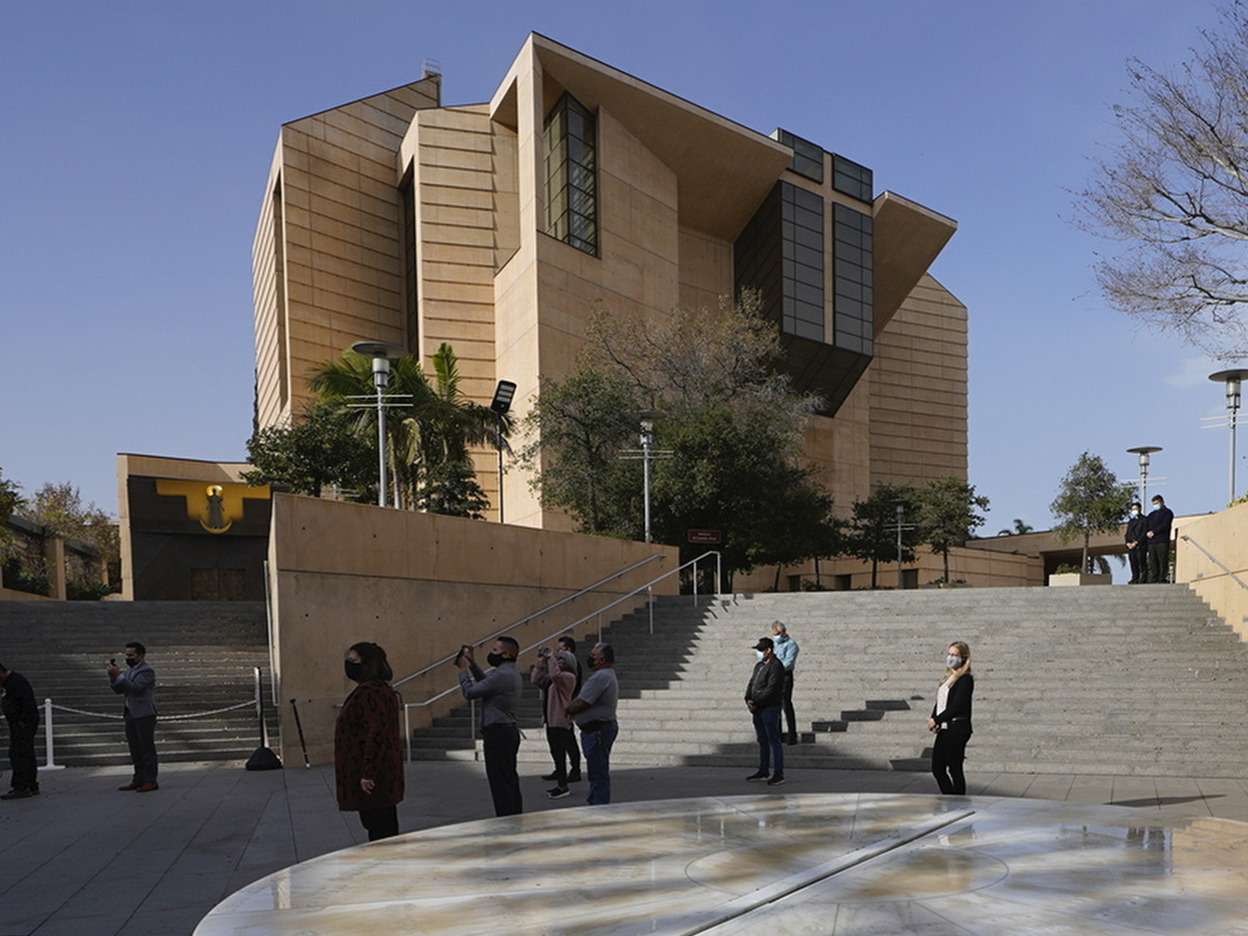 FILE - People attend a memorial service outside the Cathedral of Our Lady of Angels in Los Angeles, Jan. 19, 2021. (AP Photo/Damian Dovarganes,File)