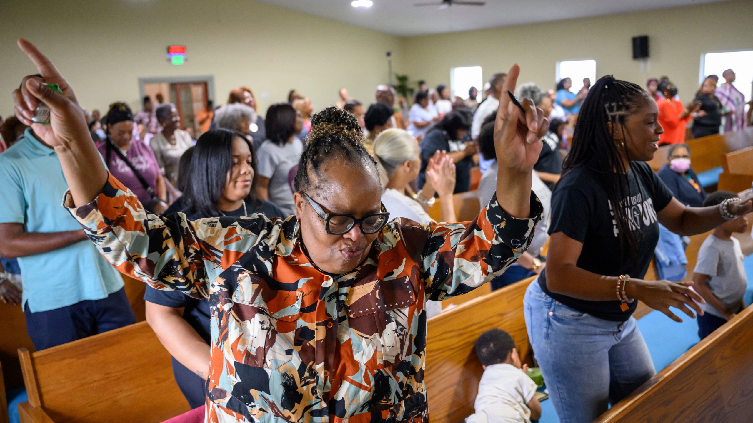 Peggy Whitfield, left, of Baltimore, attends a service at Mt. Olive Baptist Church, Sunday, Aug. 18, 2024, in Turner Station, Md. Turner Station is located near the former site of the Francis Scott Key Bridge, which collapsed in March. (AP Photo/Steve Ruark)