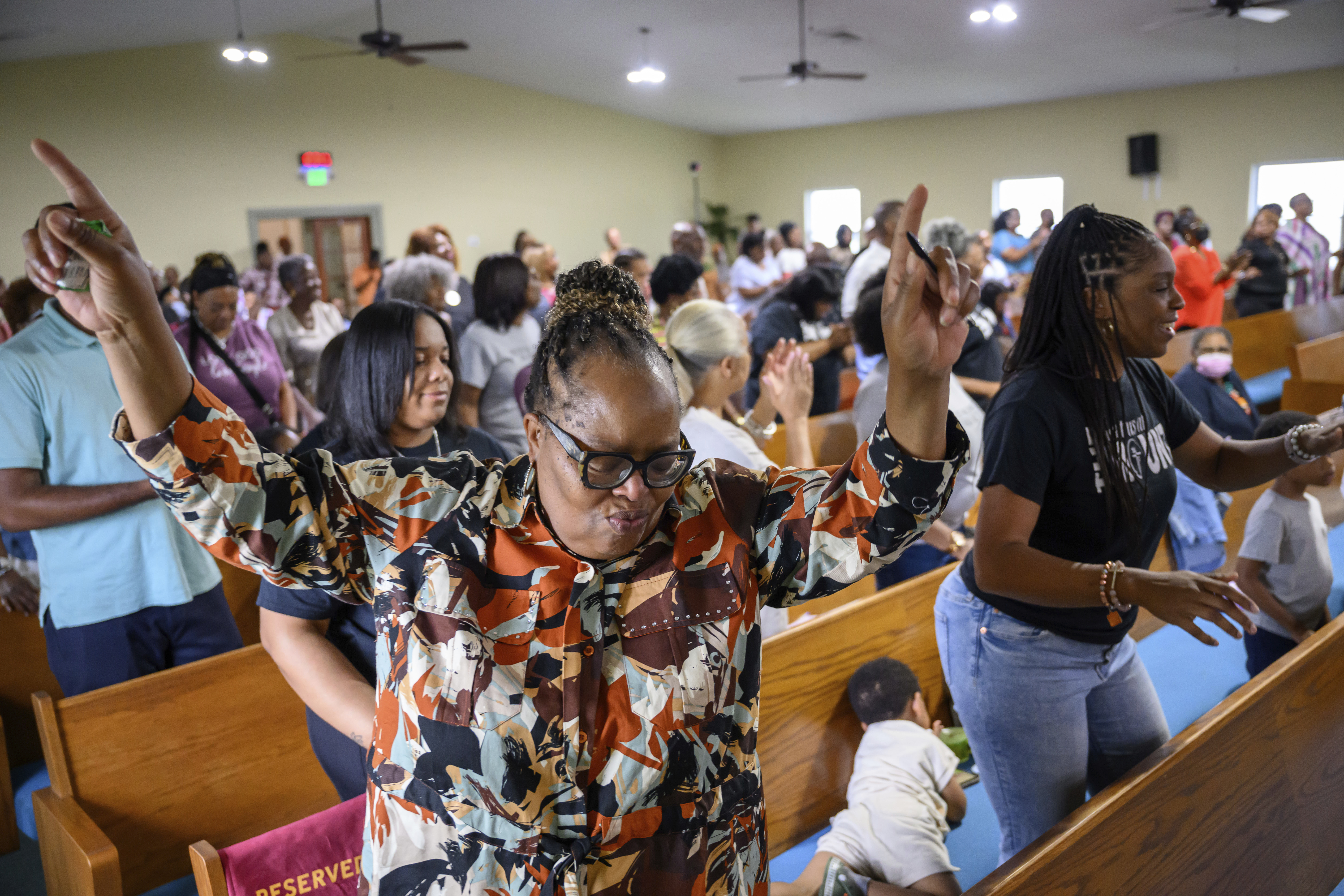 Peggy Whitfield, left, of Baltimore, attends a service at Mt. Olive Baptist Church, Sunday, Aug. 18, 2024, in Turner Station, Md. Turner Station is located near the former site of the Francis Scott Key Bridge, which collapsed in March. (AP Photo/Steve Ruark)