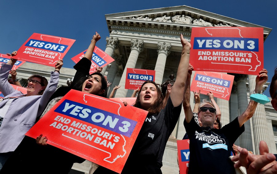 FILE - Amendment 3 supporters Luz Maria Henriquez, second from left, executive director of the ACLU Missouri, celebrates with Mallory Schwarz, center, of Abortion Action Missouri, after the Missouri Supreme Court in Jefferson City, Mo., ruled that the amendment to protect abortion rights would stay on the November ballot in on Tuesday, Sept. 10, 2024. (Robert Cohen/St. Louis Post-Dispatch via AP, File)