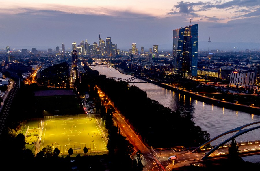 FILE - The European Central Bank stands at right as soccer players practise on a field next to the river Main, in Frankfurt, Germany, late Thursday, Sept. 19, 2024. (AP Photo/Michael Probst, File)