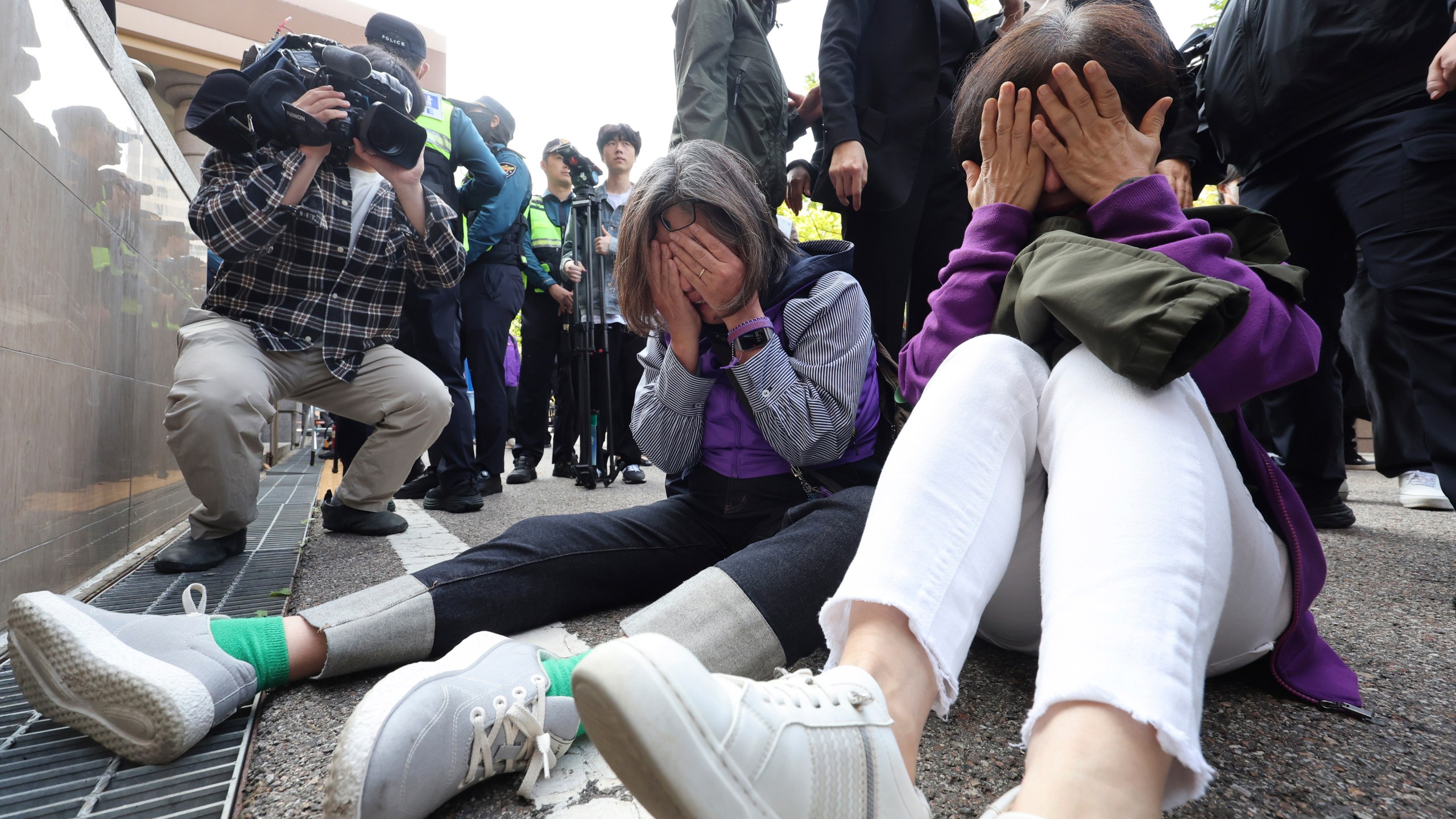 Bereaved family members of the victims of the Halloween crush in 2022 react at the Seoul Western District Court in Seoul, South Korea, Thursday, Oct. 17, 2024. (Lim Hwa-young/Yonhap via AP)