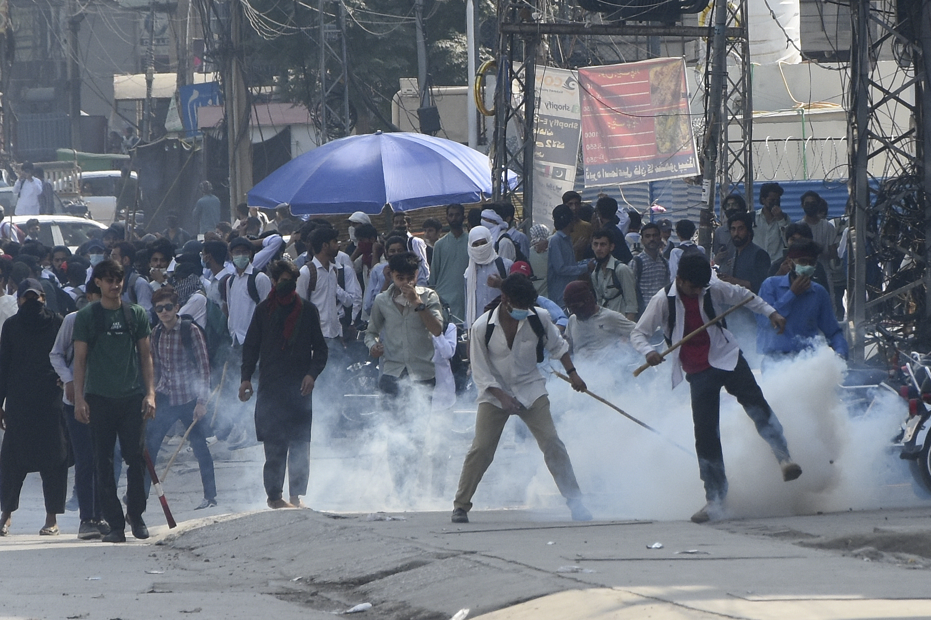 Police fire tear gas to disperse students protesting over an alleged on-campus rape in Punjab, in Rawalpindi, Pakistan, Thursday, Oct. 17, 2024. (AP Photo/W.K. Yousafzai).