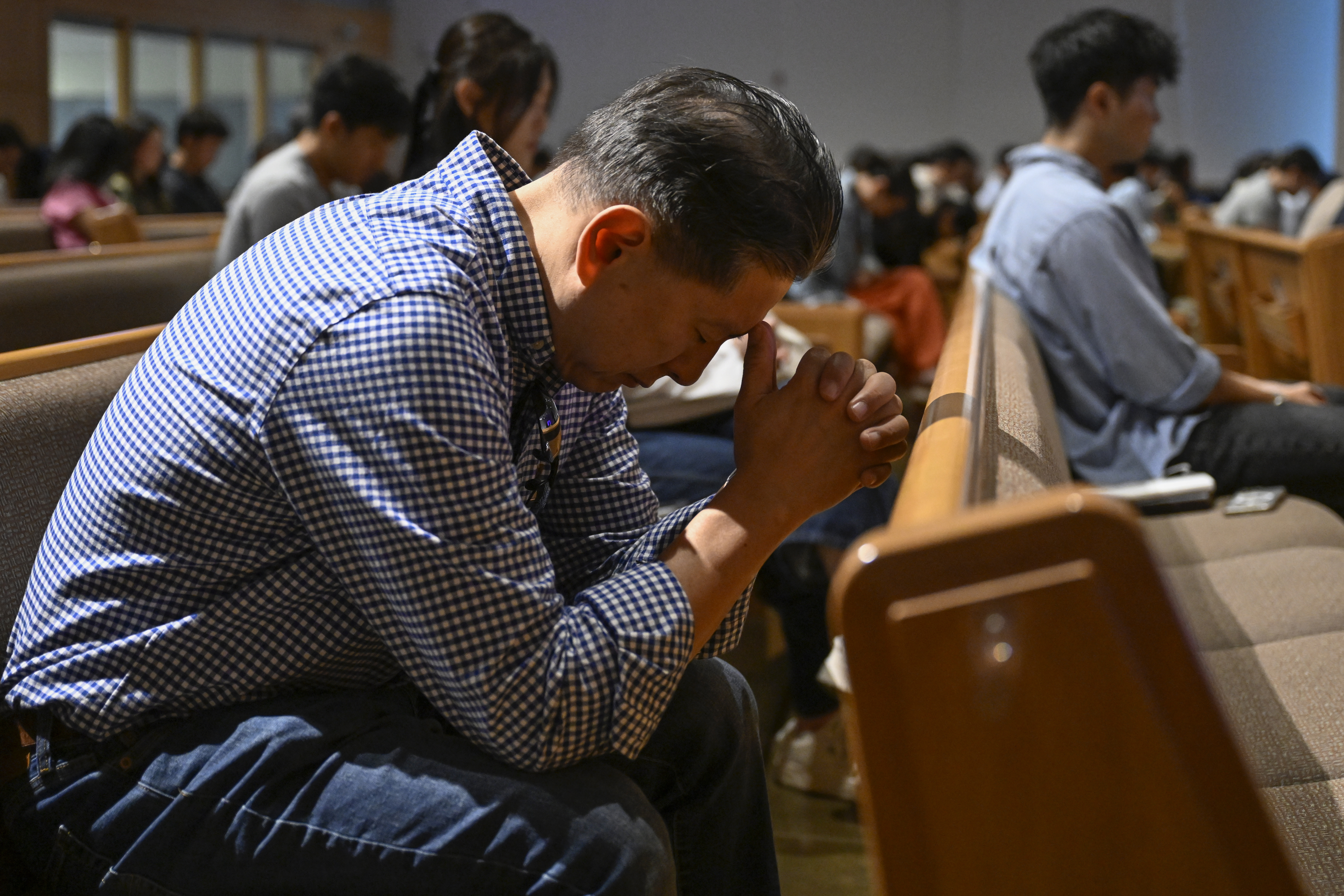 A parishioner prays during a service at the Christ Central Presbyterian Church, Sunday, Oct. 13, 2024 in Centreville. (AP Photo/John McDonnell)