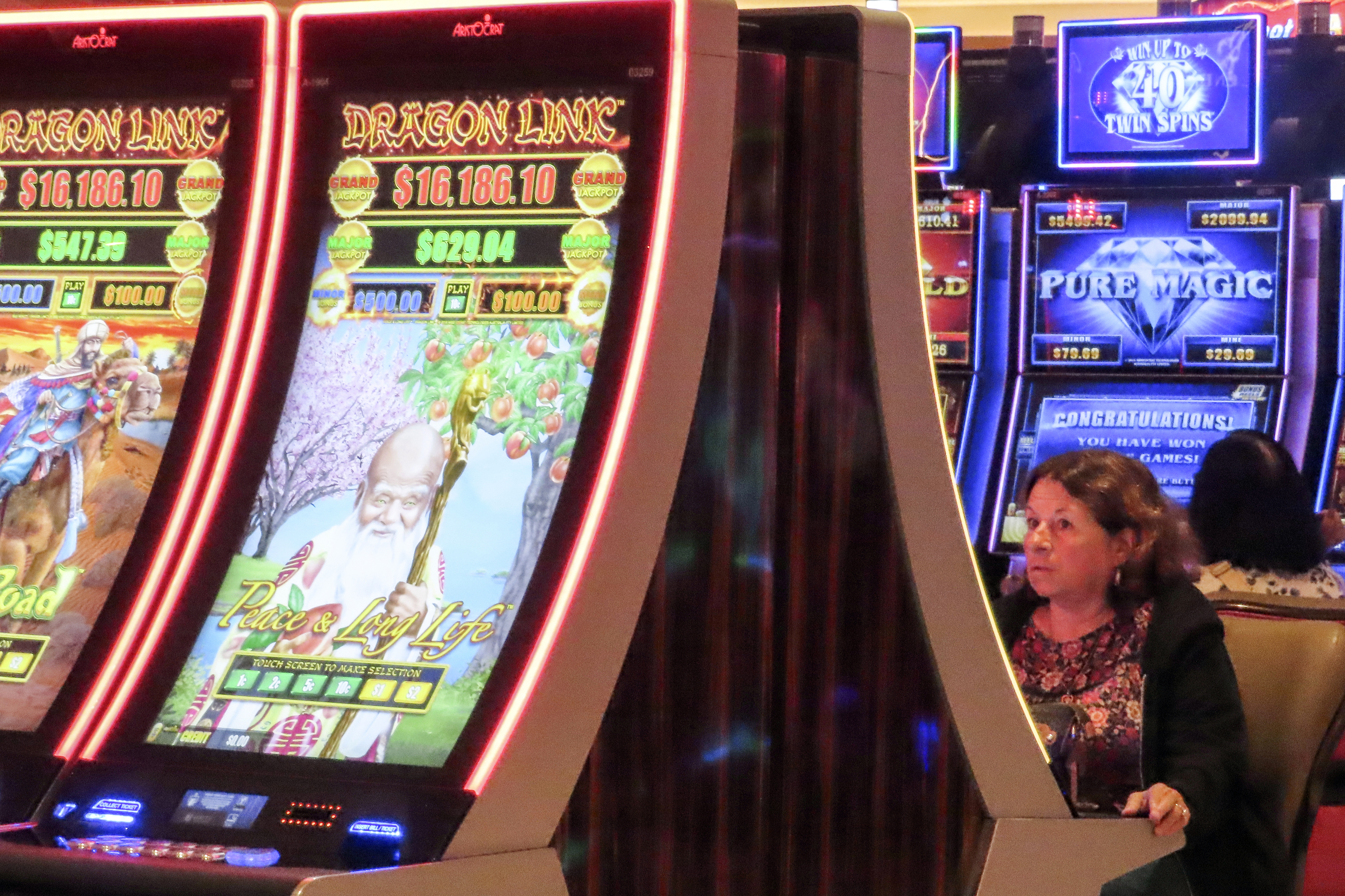 A gambler plays a slot machine at the Hard Rock casino in Atlantic City, N.J., Thursday, Oct. 3, 2024. (AP Photo/Wayne Parry)