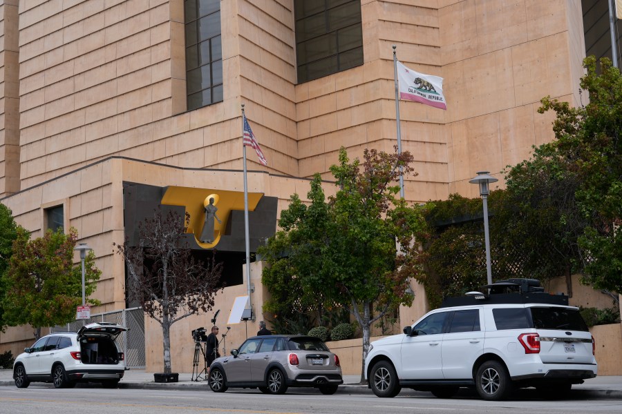 Television news crews report the largest single child sex abuse settlement with a Catholic archdiocese outside the Cathedral of Our Lady of Angels in Los Angeles, Thursday, Oct. 17, 2024. The Archdiocese of Los Angeles has agreed to pay $880 million to victims of clergy sexual abuse dating back decades. (AP Photo/Damian Dovarganes)