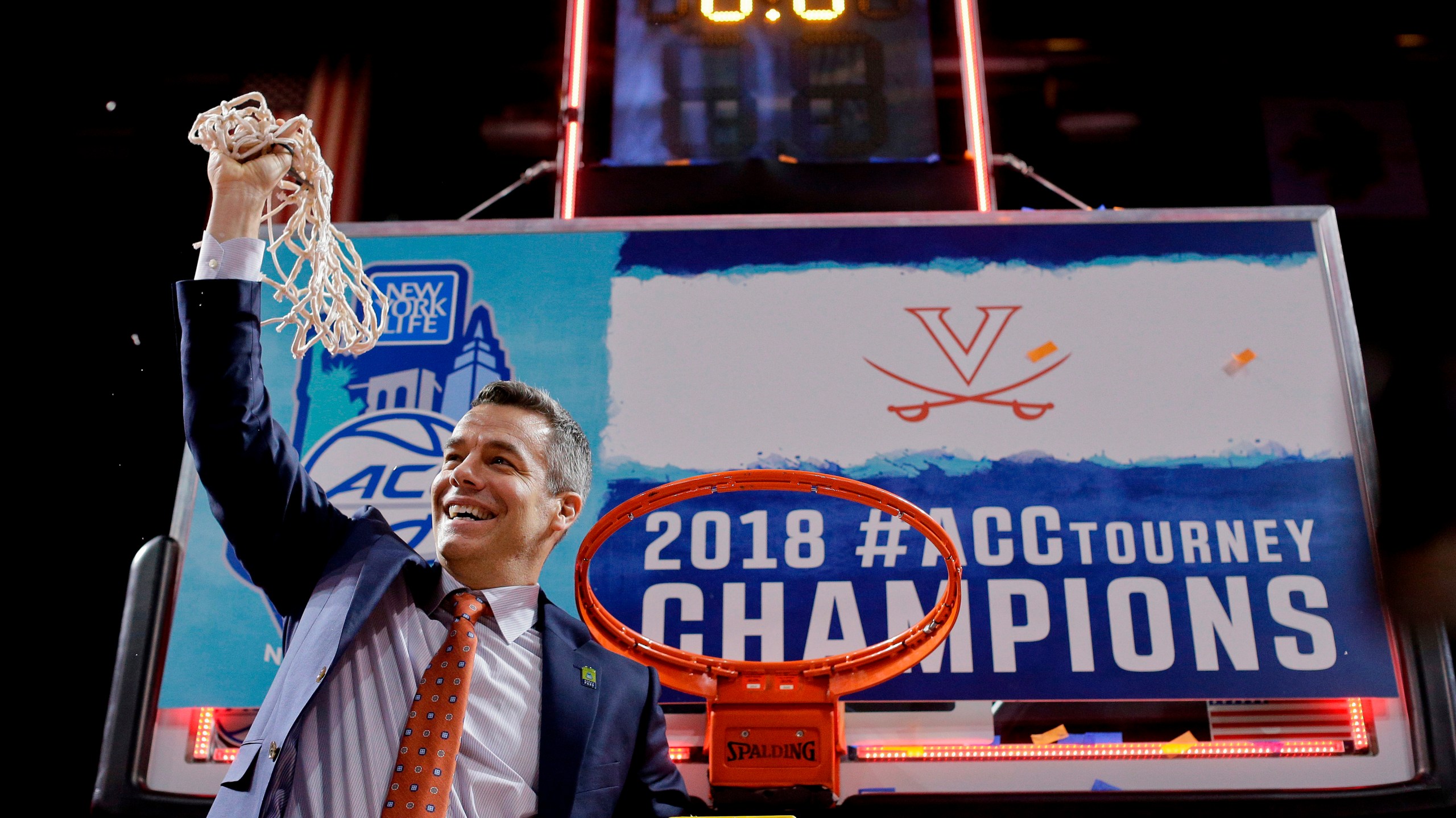 FILE - Virginia head coach Tony Bennett holds up the net after defeating North Carolina in the championship game of the NCAA Atlantic Coast Conference men's college basketball tournament in New York, March 10, 2018. (AP Photo/Julie Jacobson, File)