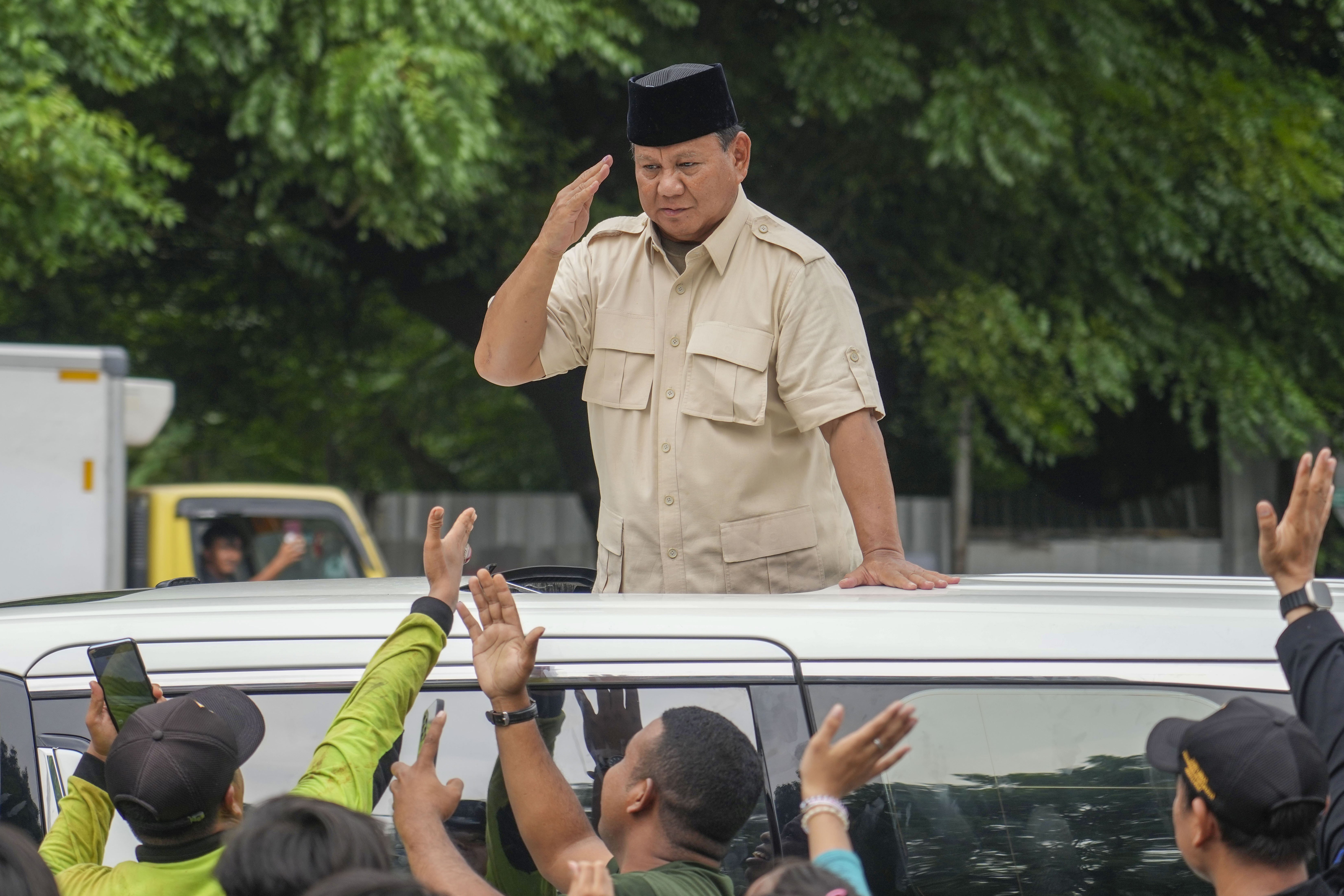 FILE - Indonesian Defense Minister and presidential frontrunner Prabowo Subianto greets supporters after visiting his father's grave in Jakarta, Indonesia Thursday, Feb. 15, 2024. (AP Photo/Tatan Syuflana, File)