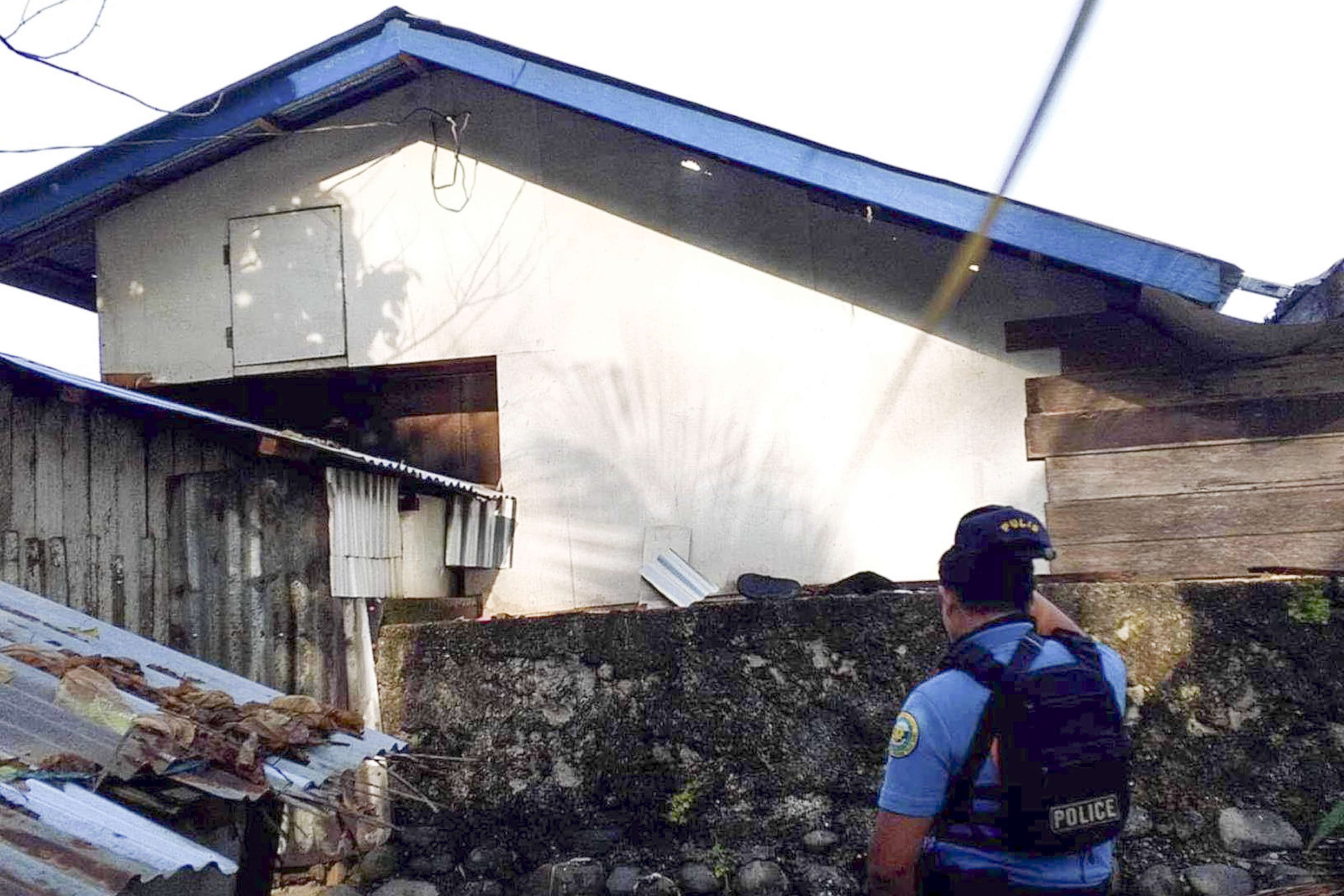 In this photo provided by the Philippine National Police Regional Office 9, a policeman checks an area Friday Oct. 18, 2024, where an American identified as Elliot Onil Eastman, from Vermont, was reportedly abducted by gunmen in Sibuco town, Zamboanga del Norte province, southern Philippines. (Philippine National Police Regional Office 9 via AP)