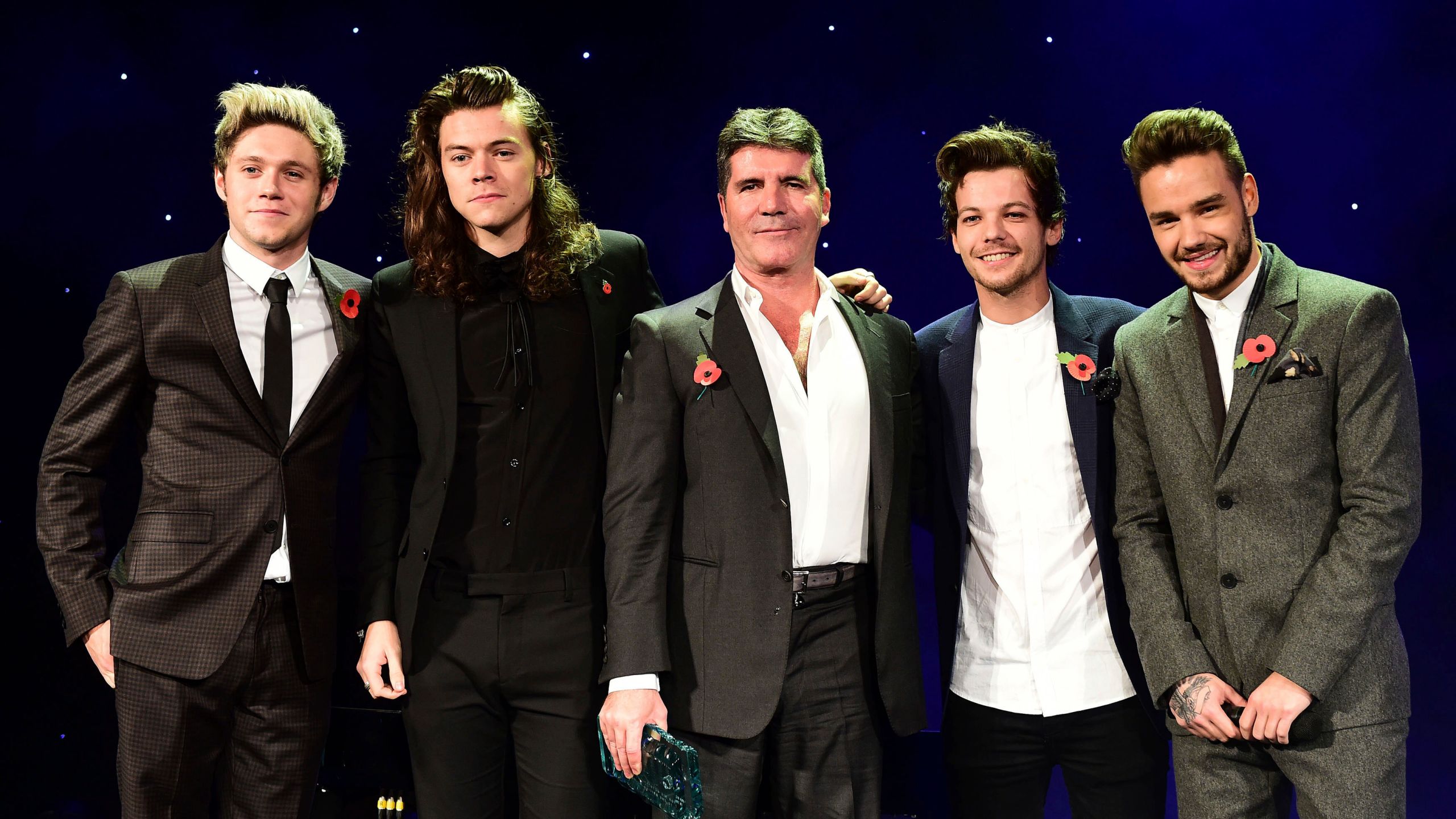 FILE - One Direction's Niall Horan, from left, Harry Styles , Simon Cowell, Louis Tomlinson and Liam Payne present the Music Industry Trust Award to Simon Cowell at the Music Industry Trusts Award (MITS) in aid of charities Nordon Robbins and Brit Trust at the Grosvenor House Hotel, in London, Nov. 2, 2015. (Dominic Lipinski/PA via AP)