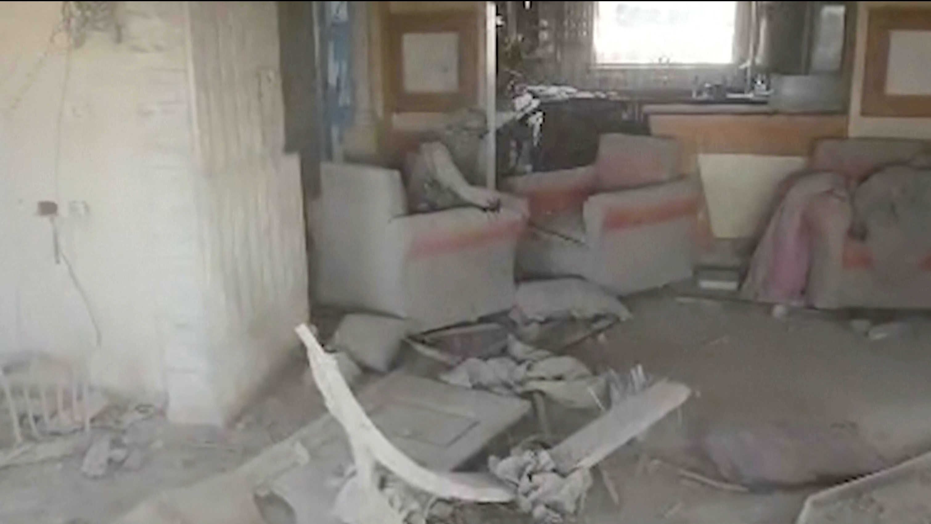 This still image from video provided by the Israel Defense Force (IDF) shows a heavily damaged building with a person the Israeli military identified as Hamas leader Yahya Sinwar seated in a chair in Rafah, Gaza Strip, on Wednesday, Oct. 16, 2024. (Israel Defense Force via AP)