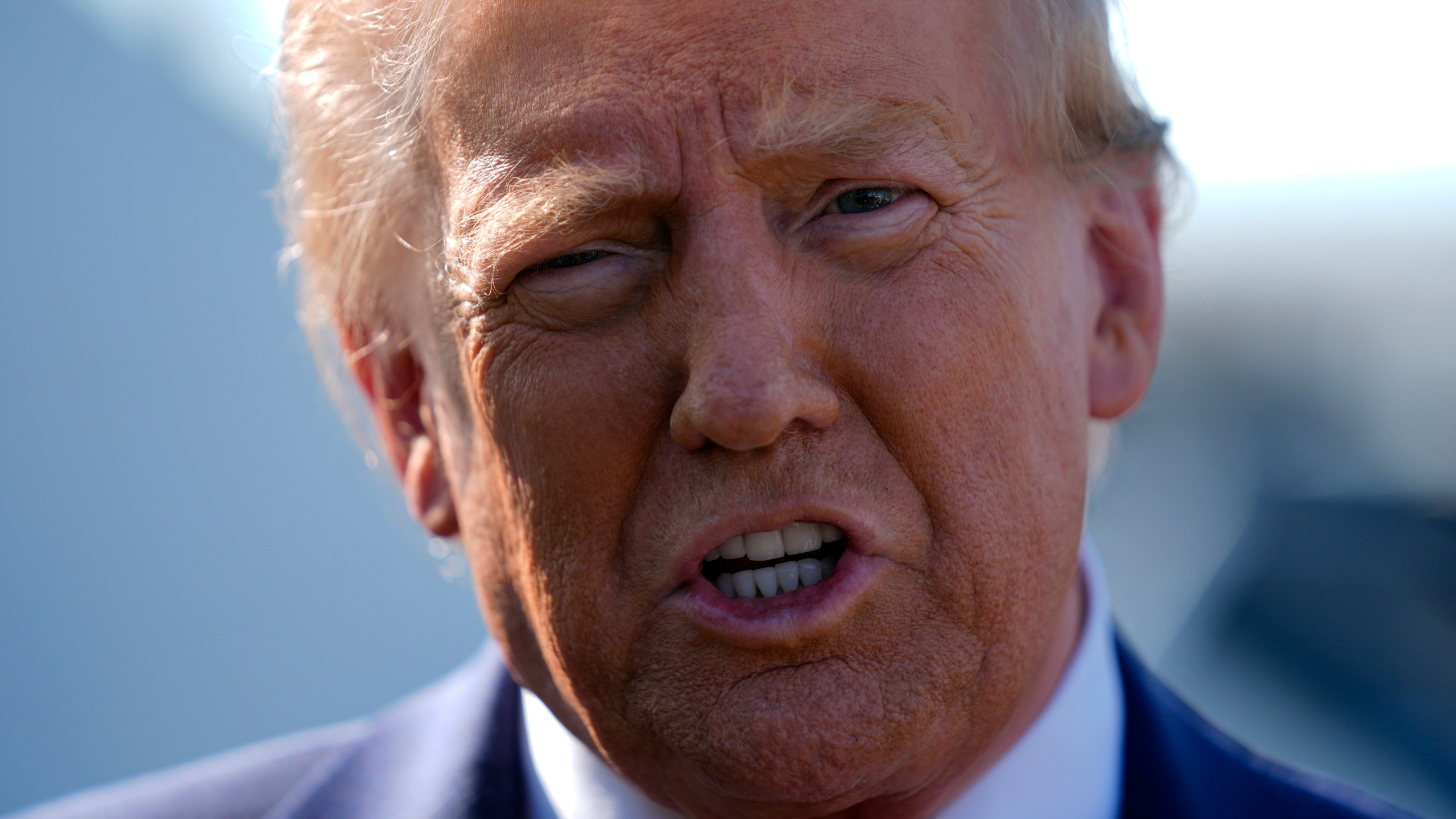 Republican presidential nominee former President Donald Trump speaks to reporters as he arrives at Detroit Metropolitan Wayne County Airport, Friday, Oct. 18, 2024, in Detroit. (AP Photo/Evan Vucci)