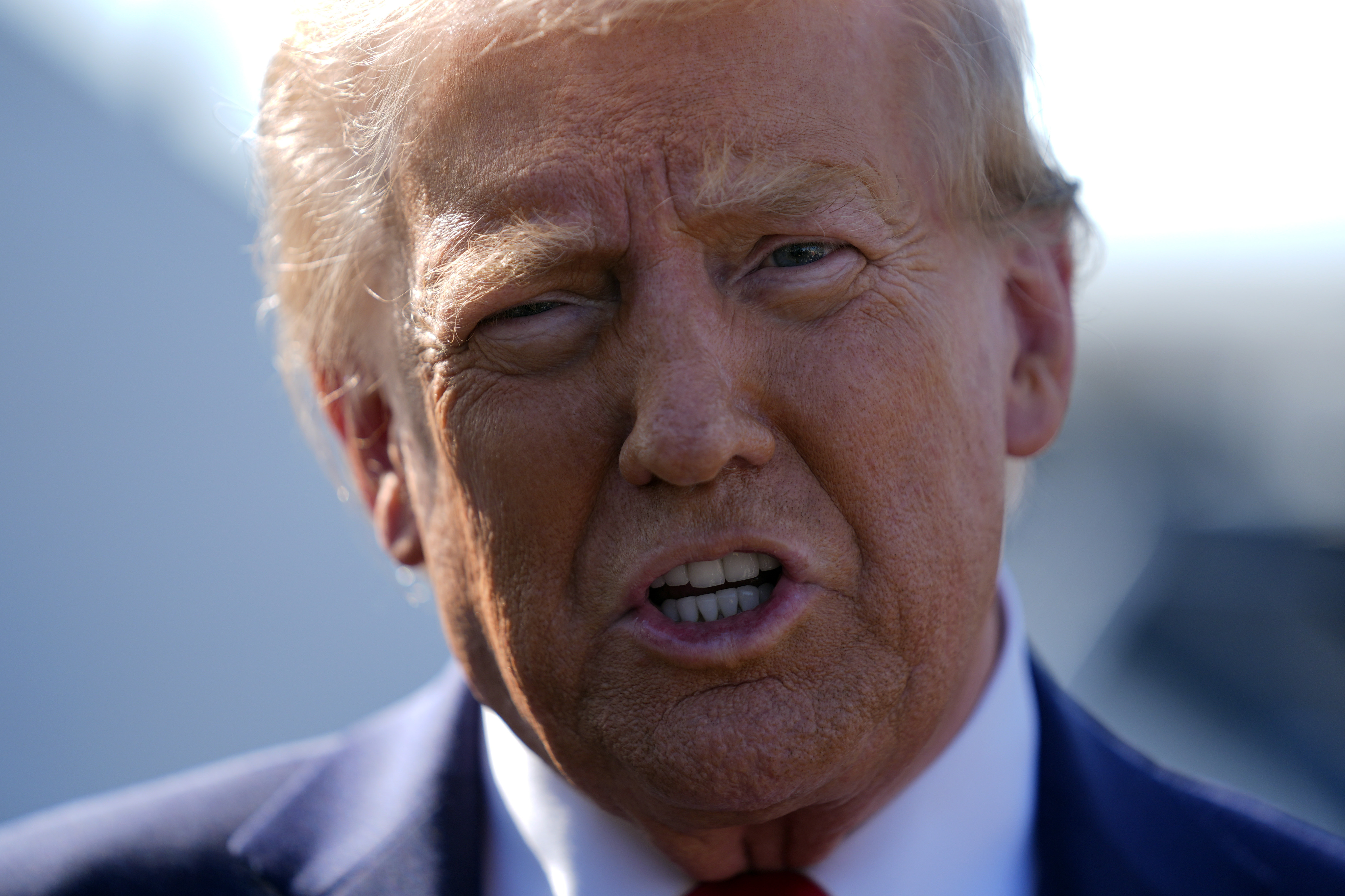 Republican presidential nominee former President Donald Trump speaks to reporters as he arrives at Detroit Metropolitan Wayne County Airport, Friday, Oct. 18, 2024, in Detroit. (AP Photo/Evan Vucci)