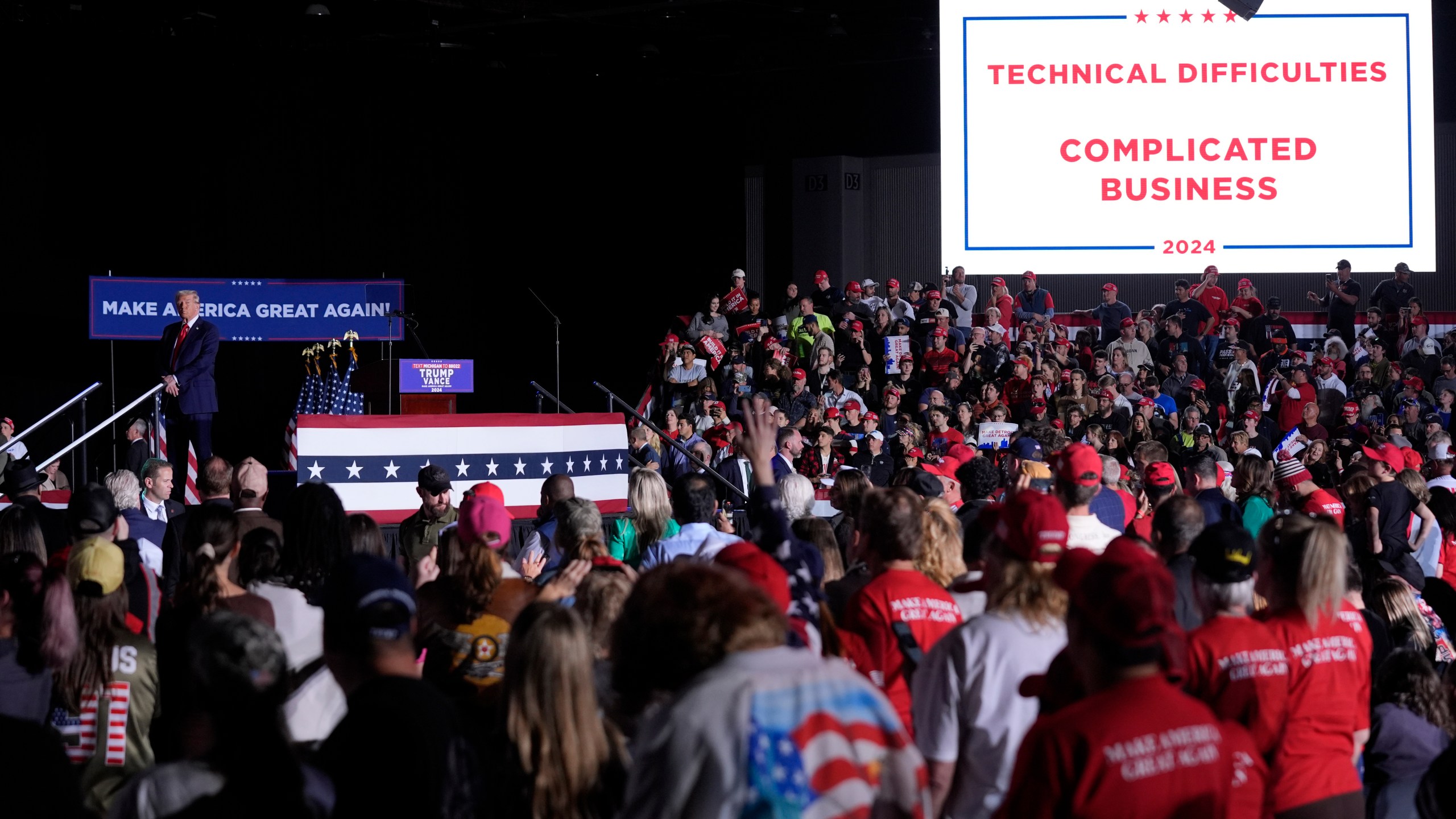 Republican presidential nominee former President Donald Trump pauses during technical difficulties at a campaign rally, Friday, Oct. 18, 2024, in Detroit. (AP Photo/Evan Vucci)