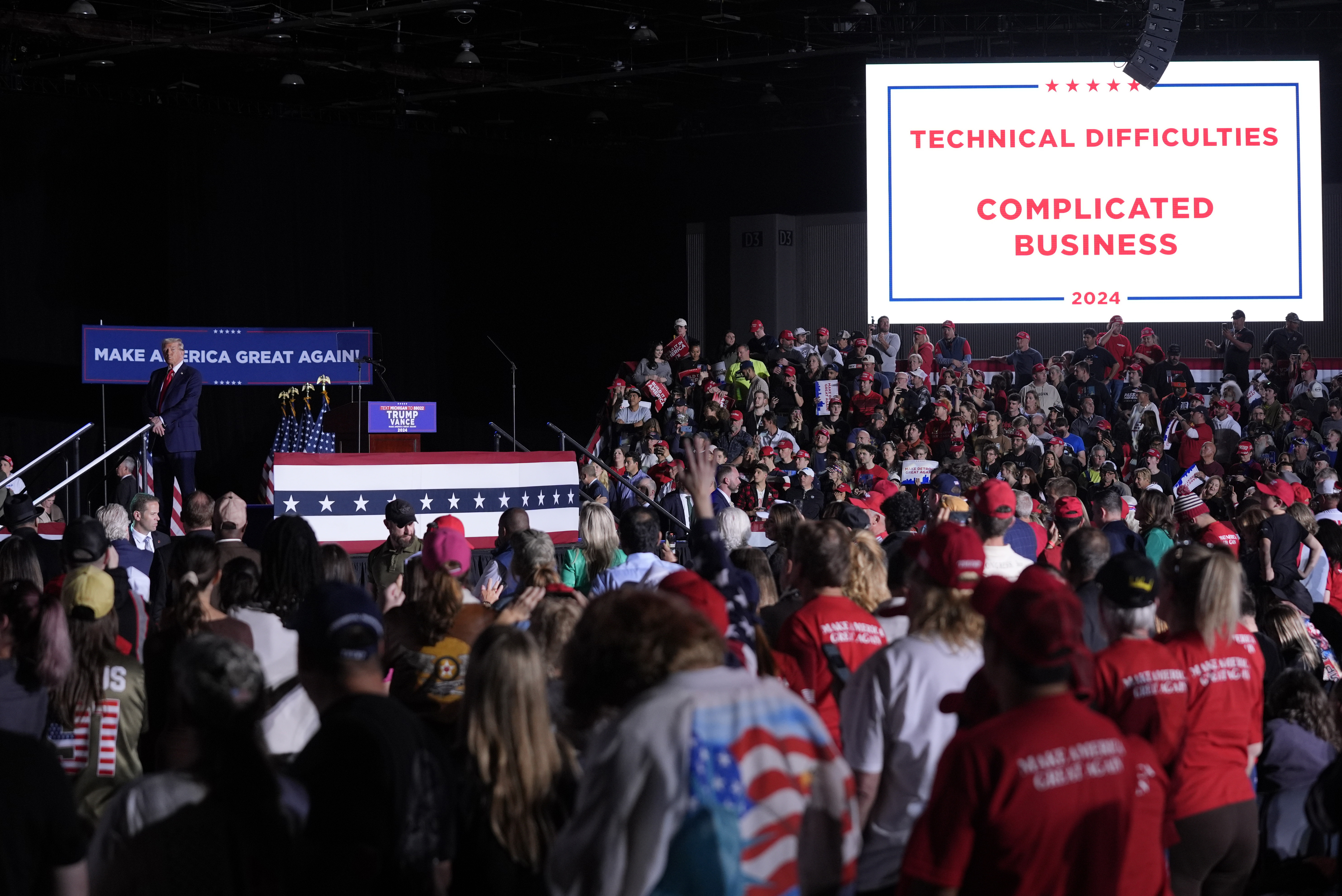 Republican presidential nominee former President Donald Trump pauses during technical difficulties at a campaign rally, Friday, Oct. 18, 2024, in Detroit. (AP Photo/Evan Vucci)