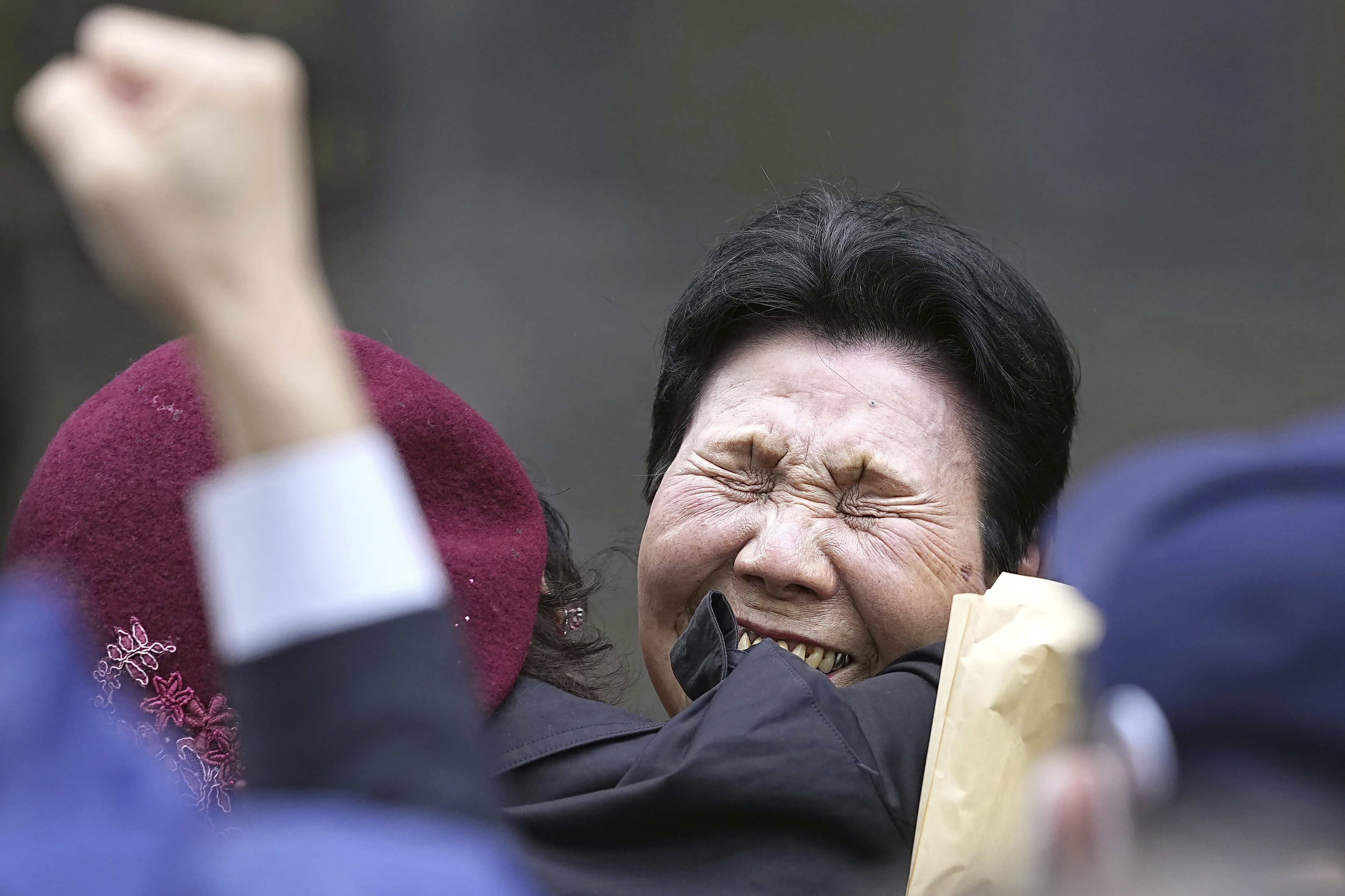 Hideko Hakamada, center right, sister of former boxer Iwao Hakamada who has been on death row for a 1966 quadruple murder case, celebrates with a supporter after Tokyo High Court granted a retrial for her brother in front of the court in Tokyo, on March 13, 2023. Japanese prosecutors said on Oct. 8, 2024 they will not appeal the Sept. 26 ruling of the Shizuoka District Court that acquitted the world’s longest-serving death-row inmate in a retrial. (Kyodo News via AP)