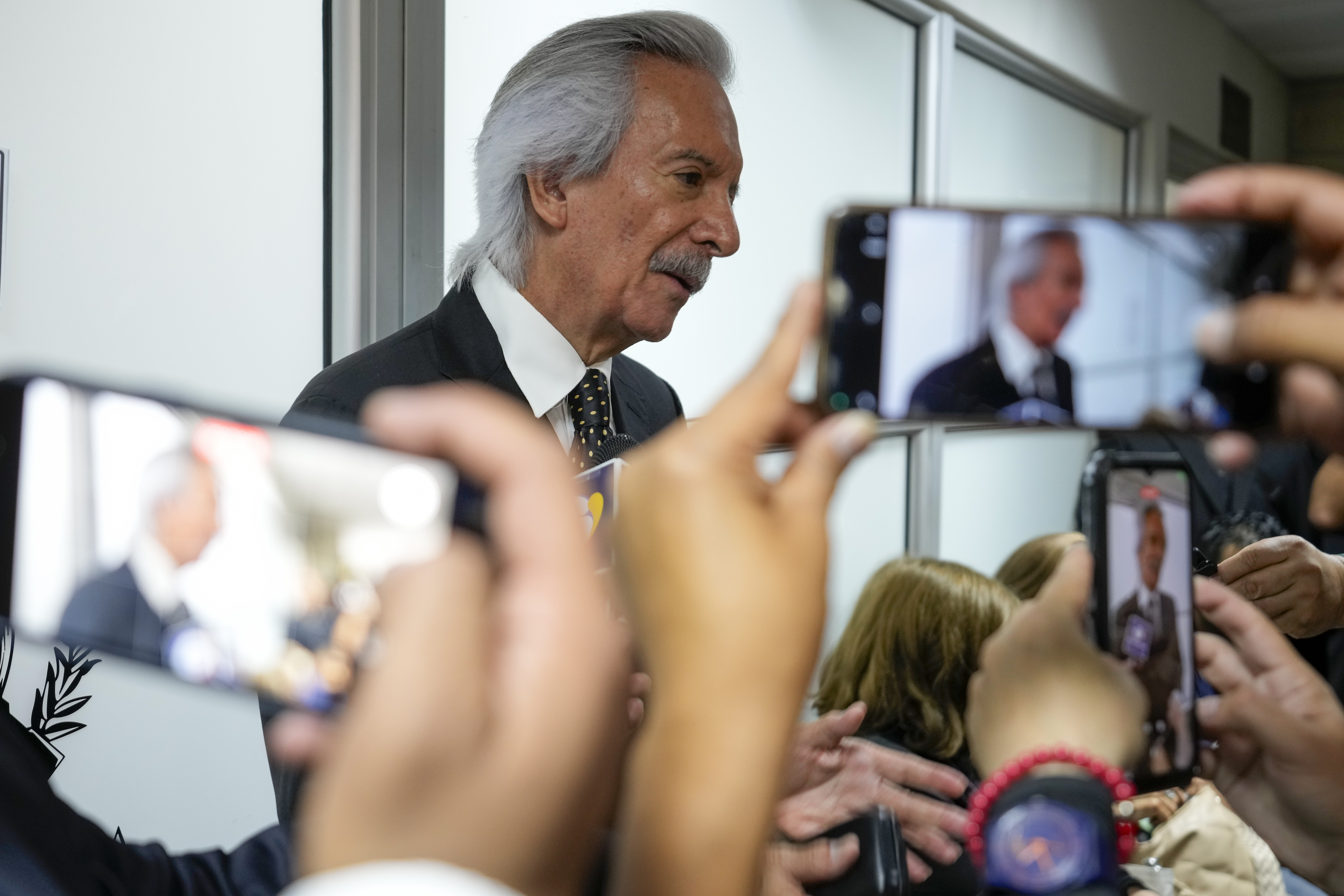 Guatemalan journalist Jose Ruben Zamora, founder of El Periodico newspaper, jailed for more than two years on money laundering charges, talks with reporters before attending a hearing to ask the judge to serve his detention at home while his judicial process continues, in Guatemala City, Friday, Oct. 18, 2024. (AP Photo/Moises Castillo)