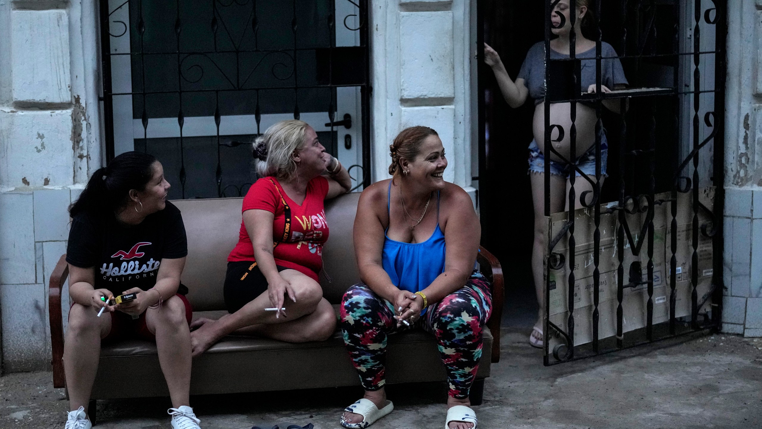 Residents pass the time during a massive blackout after a major power plant failed in Havana, Cuba, Friday, Oct. 18, 2024. (AP Photo/Ramon Espinosa)