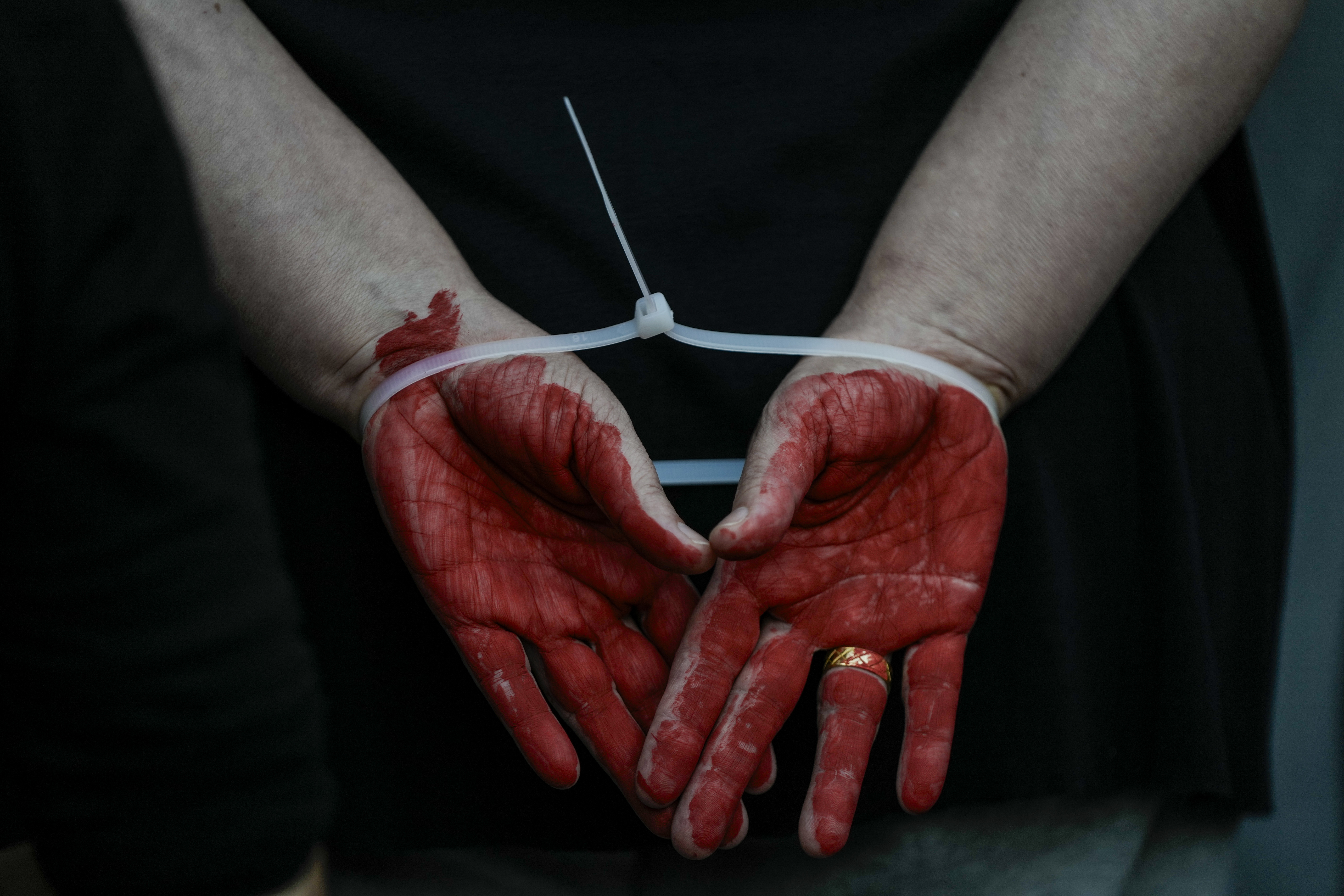 A woman demonstrator takes part in a performance calling for the release of hostage Naama Levy, held in the Gaza Strip by the Hamas militant group, in Tel Aviv, Israel, Saturday, Oct. 19, 2024. (AP Photo/Mahmoud Illean)