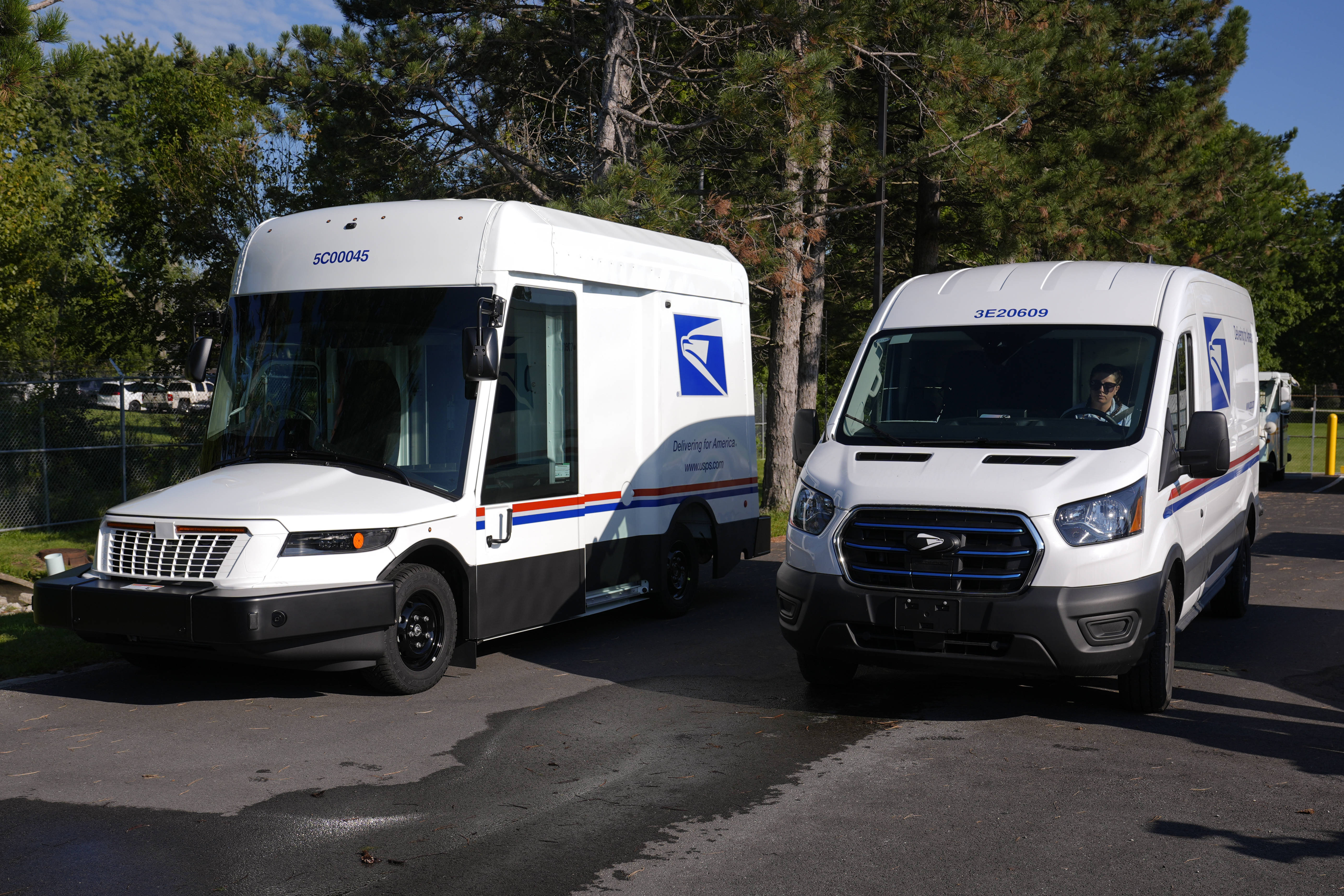 FILE - The U.S. Postal Service's next-generation delivery vehicle, left, is displayed as one new battery electric delivery trucks leaves the Kokomo Sorting and Delivery Center in Kokomo, Ind., Thursday, Aug. 29, 2024. (AP Photo/Michael Conroy, File)