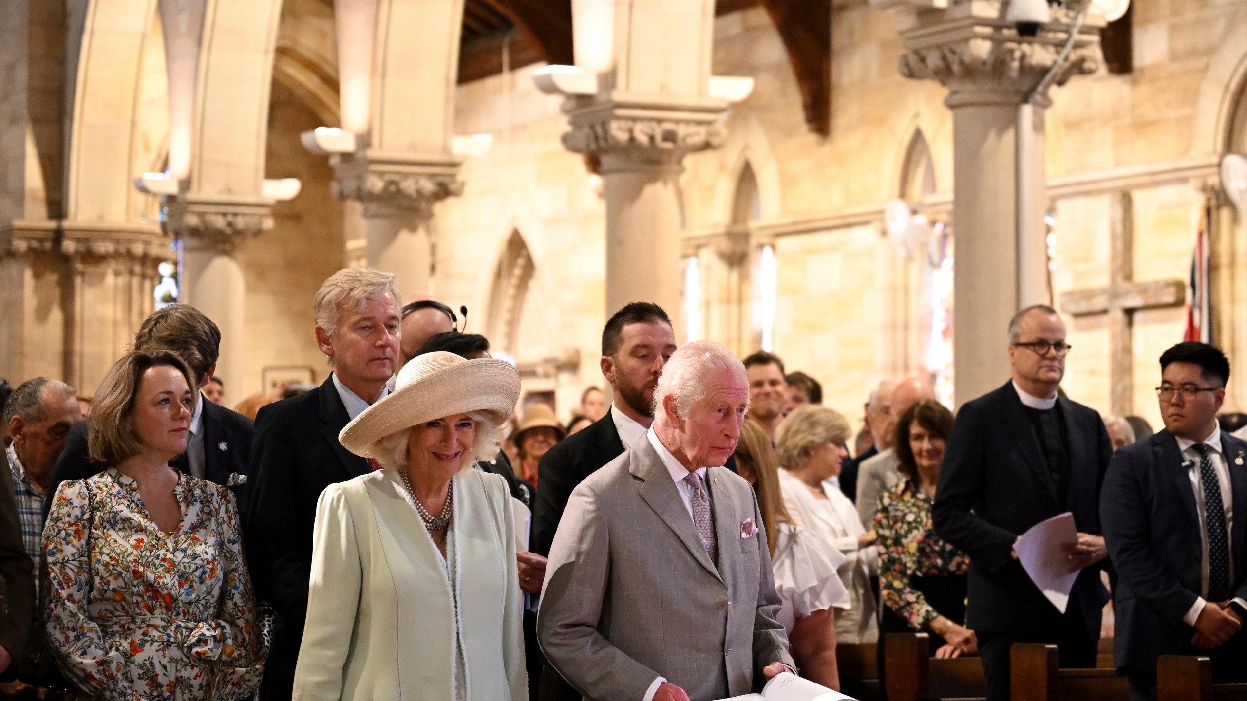 King Charles III, center right, and Queen Camilla, center left, stand during a visit to St Thomas' Anglican Church in Sydney, Sunday, Oct. 20, 2024. (Dean Lewins/Pool Photo via AP)