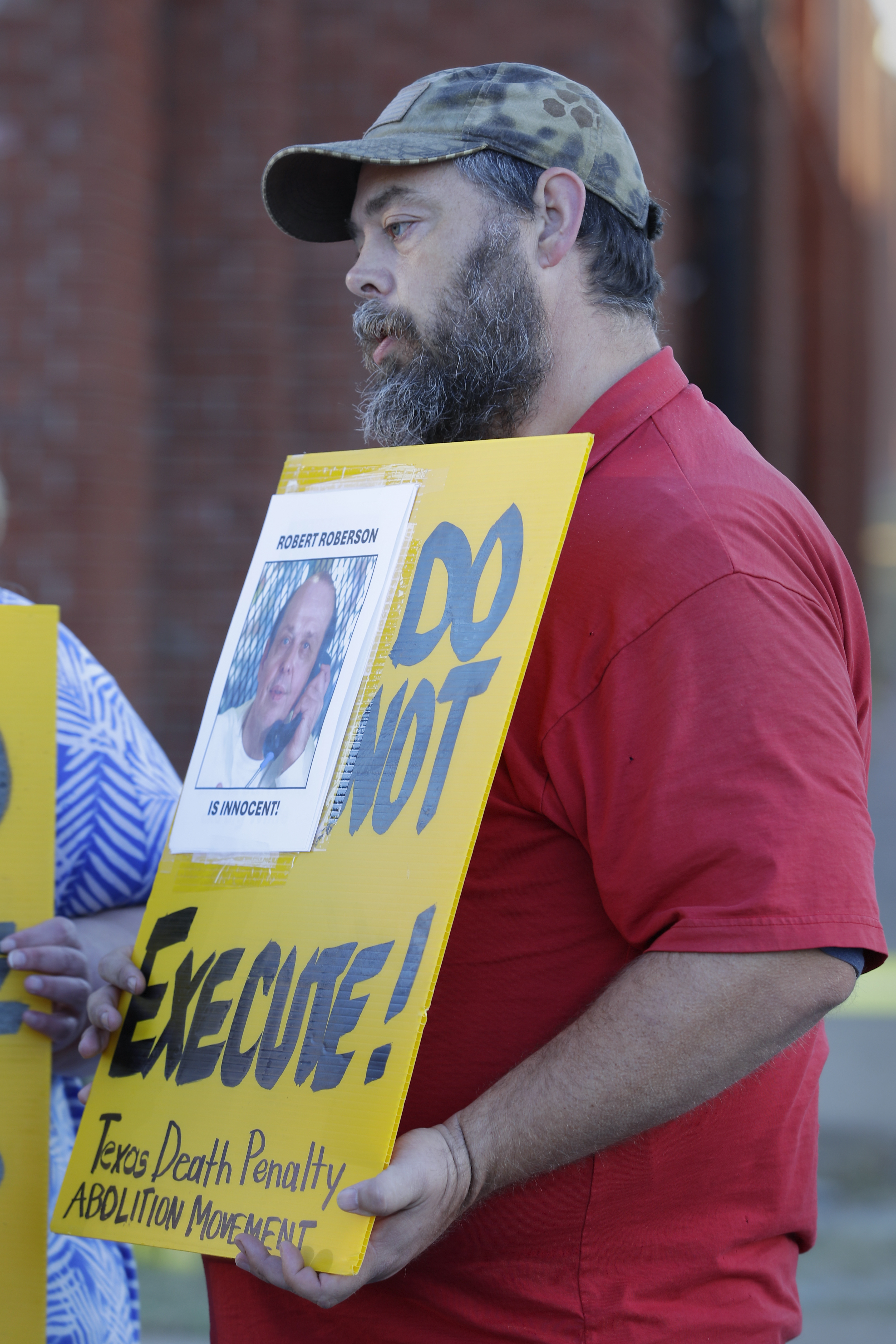 Thomas Roberson, older brother of condemned prisoner Robert Roberson, protests with others outside the prison where Roberson is scheduled for execution at the Huntsville Unit of the Texas State Penitentiary, Thursday, Oct. 17, 2024, in Huntsville, Texas. (AP Photo/Michael Wyke)