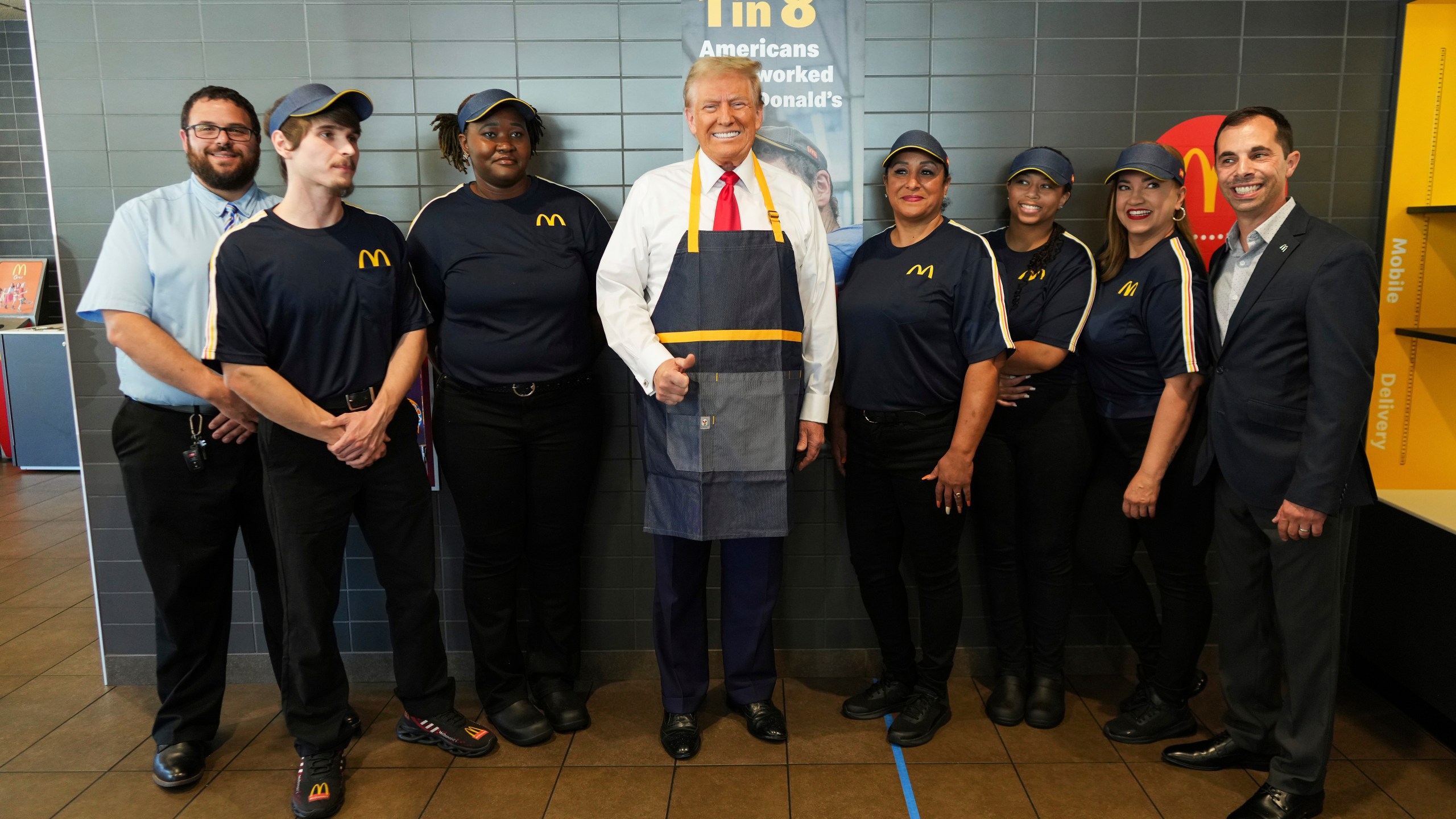 Republican presidential nominee former President Donald Trump poses with employees during a visit to McDonald's in Feasterville-Trevose, Pa., Sunday, Oct. 20, 2024. (Doug Mills/The New York Times via AP, Pool)