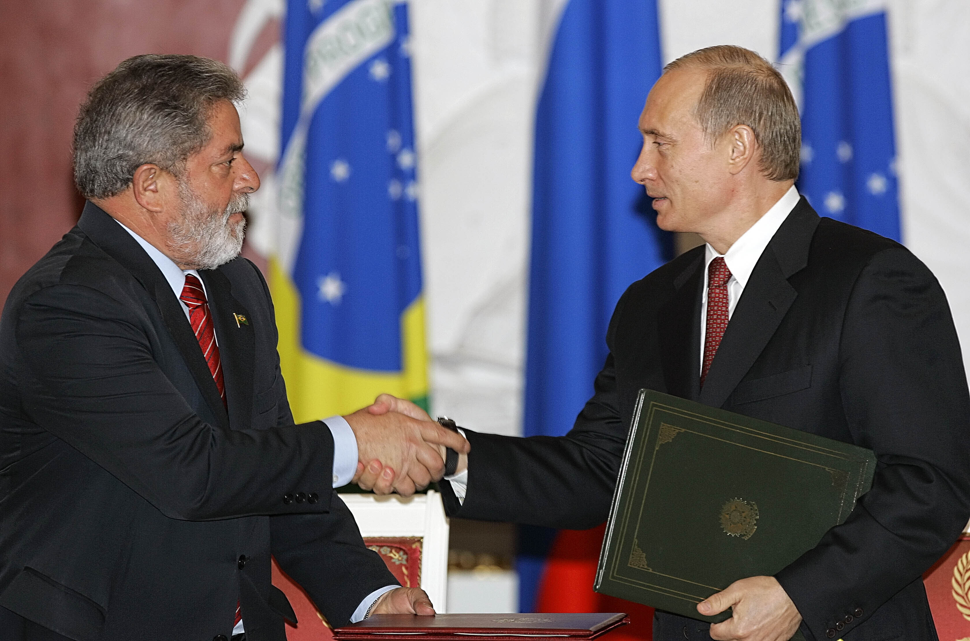 FILE - Russian President Vladimir Putin, right, and Brazilian President Luiz Inacio Lula da Silva shake hands during a ceremony in the Kremlin in Moscow, Russia, on Oct. 18, 2005. (AP Photo/Alexander Zemlianichenko, File)