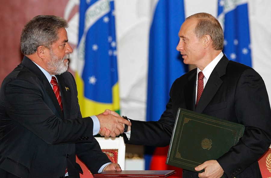 FILE - Russian President Vladimir Putin, right, and Brazilian President Luiz Inacio Lula da Silva shake hands during a ceremony in the Kremlin in Moscow, Russia, on Oct. 18, 2005. (AP Photo/Alexander Zemlianichenko, File)