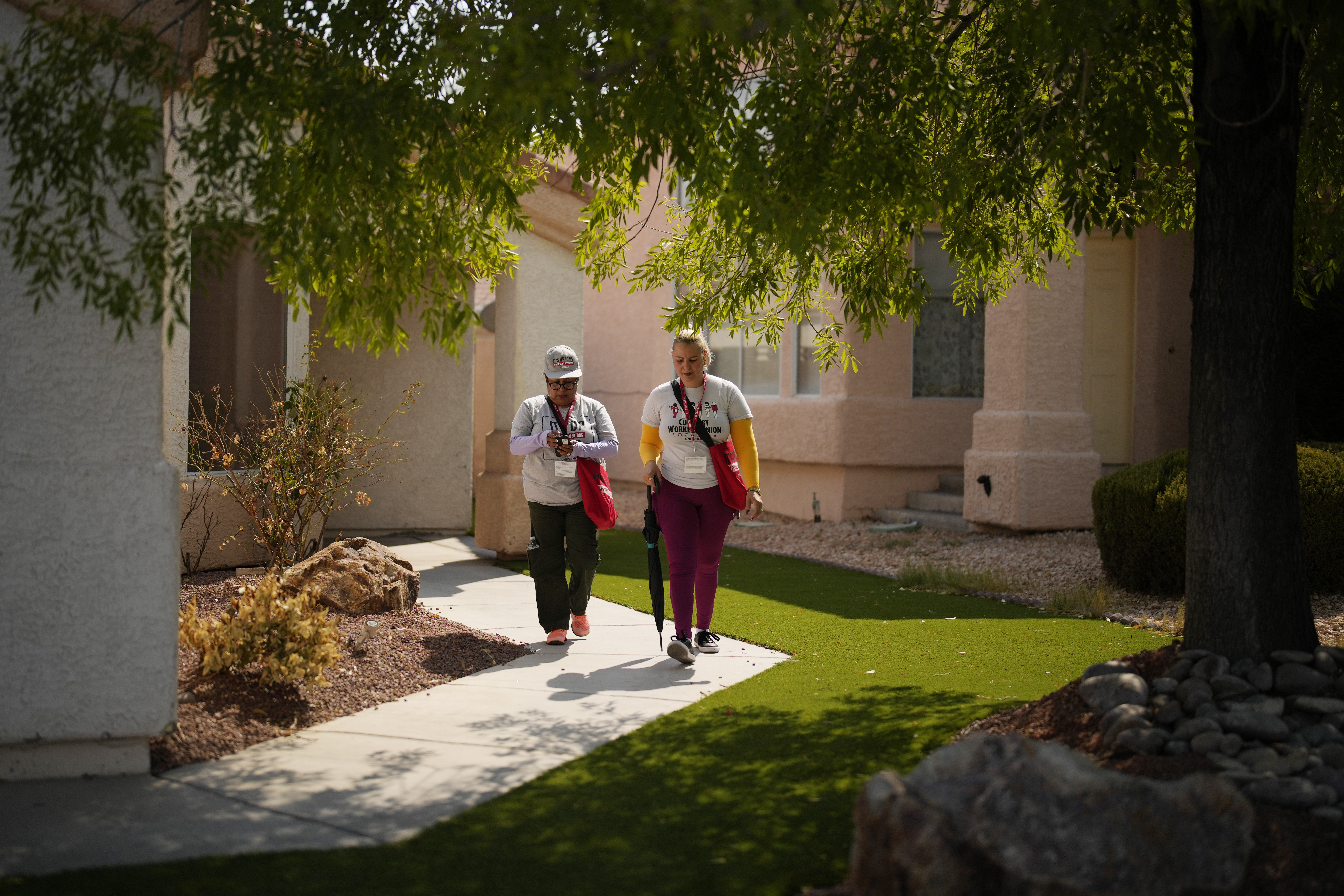 Florisela Lopez Rivera, left, canvasses with fellow Culinary Workers Union member Suldenil Alvarez, Tuesday, Sept. 10, 2024, in Las Vegas. Originally from El Salvador, Lopez Rivera recently gained permanent U.S. residency after her wife became a citizen. (AP Photo/John Locher)