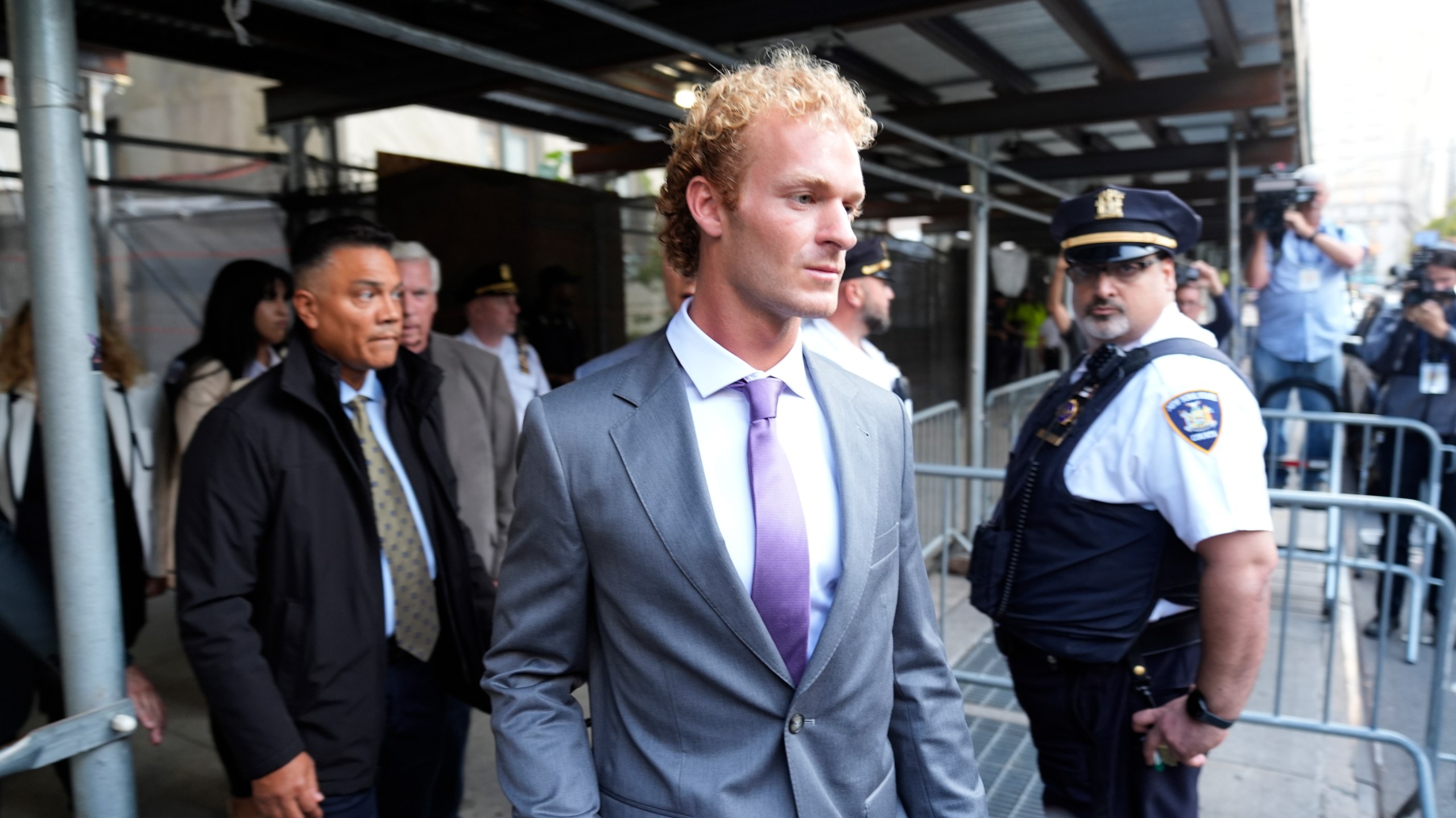 Daniel Penny, right, charged with manslaughter for placing a man in a deadly chokehold aboard a New York City subway train, departs Manhattan Criminal Court, Thursday, Oct. 3, 2024, in New York. (AP Photo/Pamela Smith)