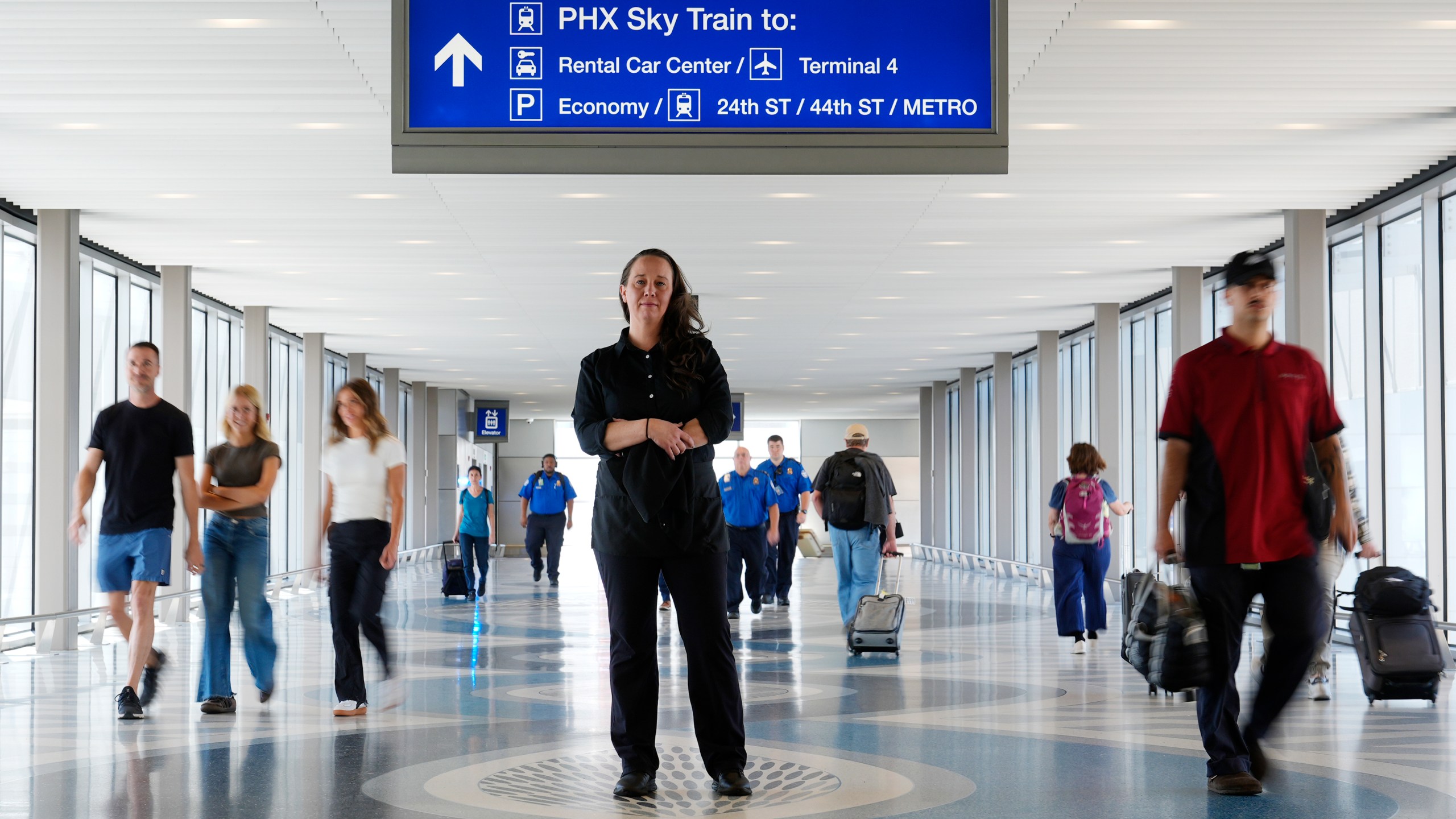 Lindsay Ruck, a server at Phoenix Sky Harbor International Airport restaurants, pauses in Terminal 3 as she is anticipates the vote on Arizona Prop 138 on minimum wage Thursday, Oct. 3, 2024, in Phoenix. (AP Photo/Ross D. Franklin)