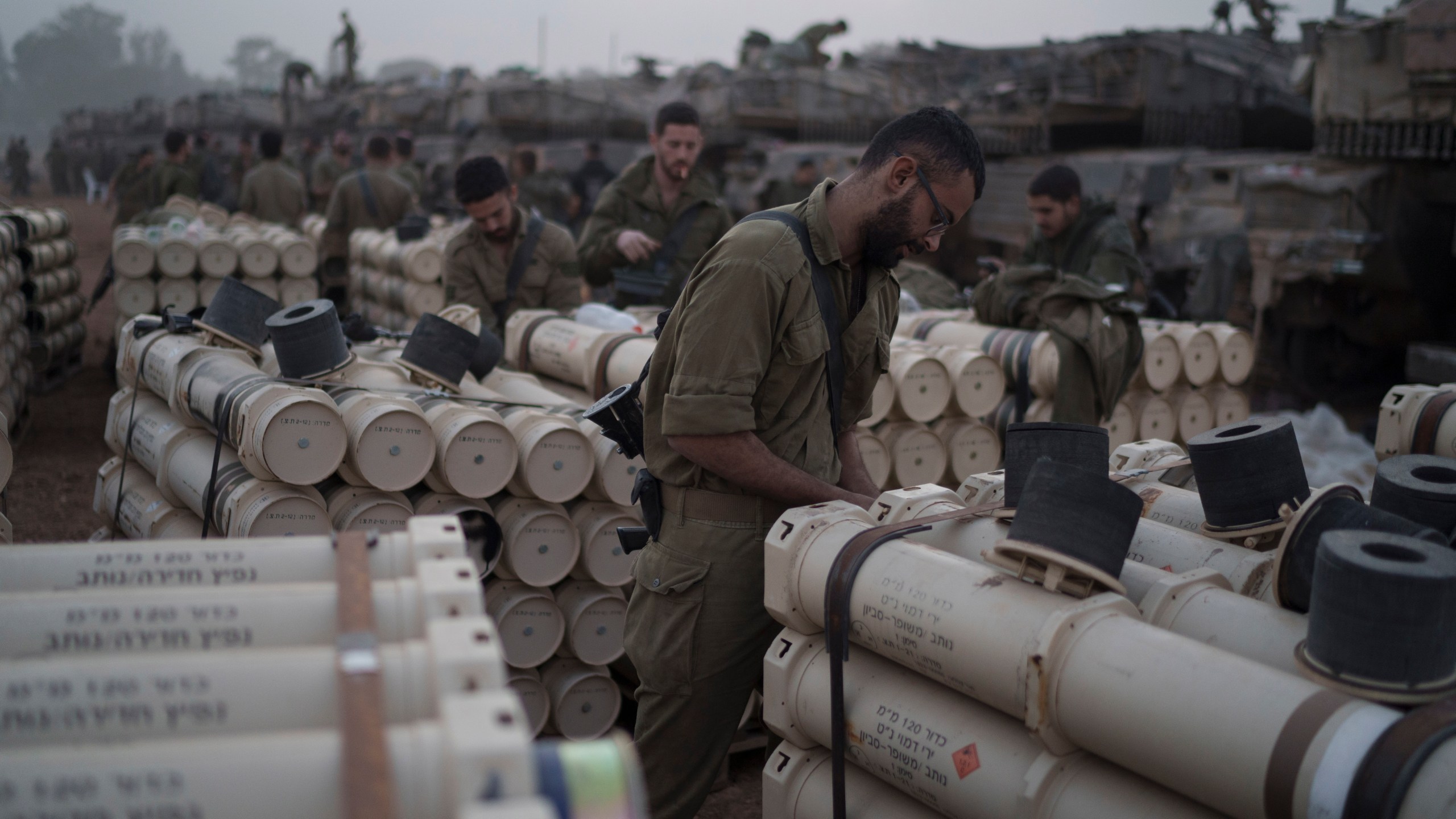 FILE - Israeli soldiers from the artillery unit store tank shells in a staging area at the Israeli-Gaza border in southern Israel, on Jan. 1, 2024. (AP Photo/Leo Correa, File)