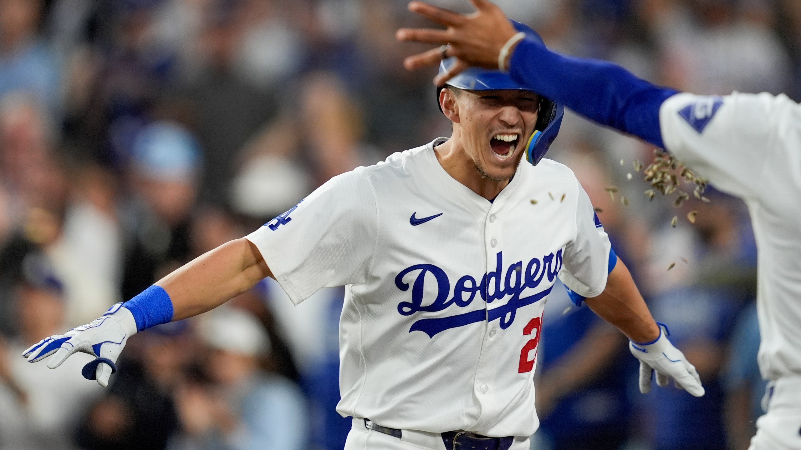 Los Angeles Dodgers' Tommy Edman celebrates a two-run home run against the New York Mets during the third inning in Game 6 of a baseball NL Championship Series, Sunday, Oct. 20, 2024, in Los Angeles. (AP Photo/Ashley Landis)