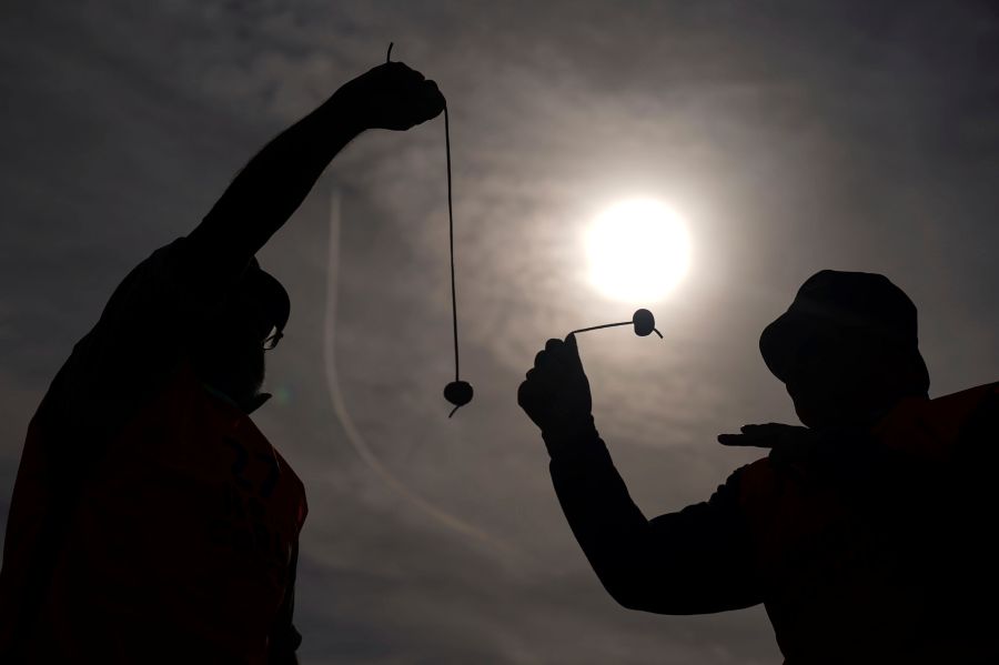 Competitors take part in the annual World Conker Championships at the Shuckburgh Arms in Southwick, Peterborough, England, Sunday Oct. 13, 2024. (Jacob King/PA via AP)