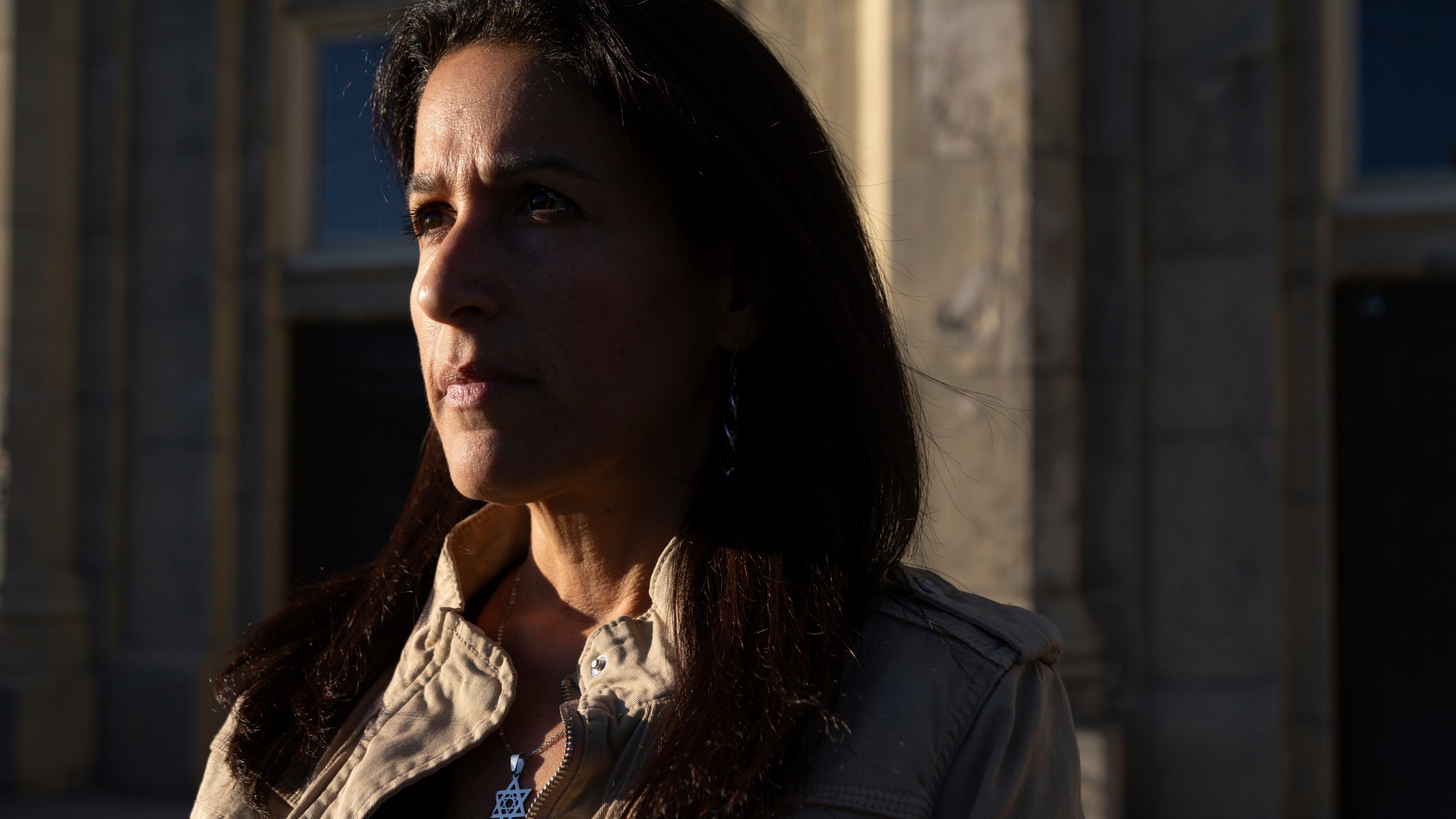 Rona Kaufman, a self-described progressive who is conflicted over who she will vote for in the presidential election, poses for a portrait outside her synagogue in Squirrel Hill, a heavily Jewish neighborhood in Pittsburgh, Saturday, Oct. 20, 2024. (AP Photo/Rebecca Droke)