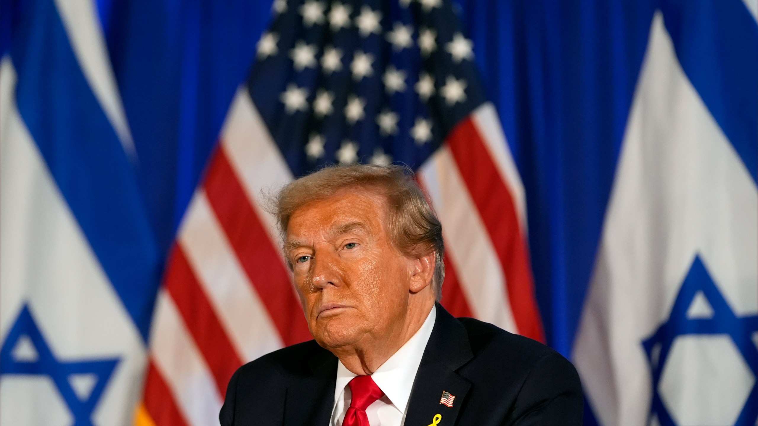 Republican presidential nominee former President Donald Trump listens at an event marking one year since the Oct. 7 Hamas attack on Israel, Monday, Oct. 7, 2024, in Miami. (AP Photo/Alex Brandon)