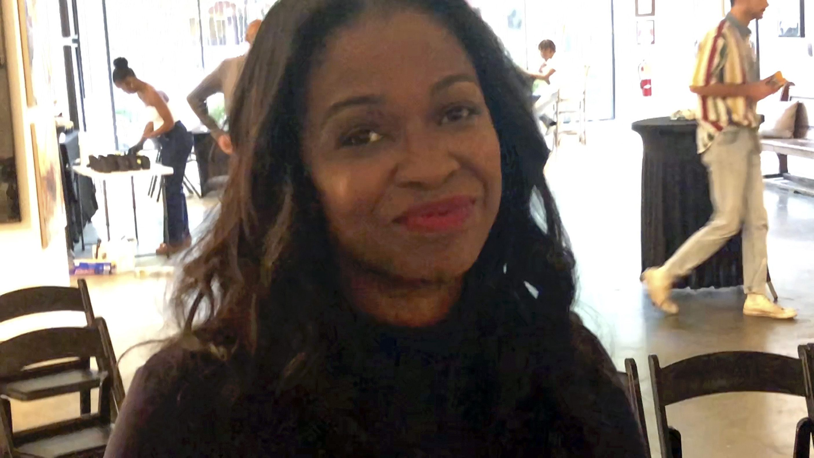 Karimah McFarlane, a Howard University graduate and owner of Buckhead Art & Company in Atlanta, poses for a photo on Sept. 10, 2024. She hosted a viewing party of the presidential debate between Republican presidential nominee former President Donald Trump and Democratic presidential nominee Vice President Kamala Harris, (AP Photo/Gary Fields)