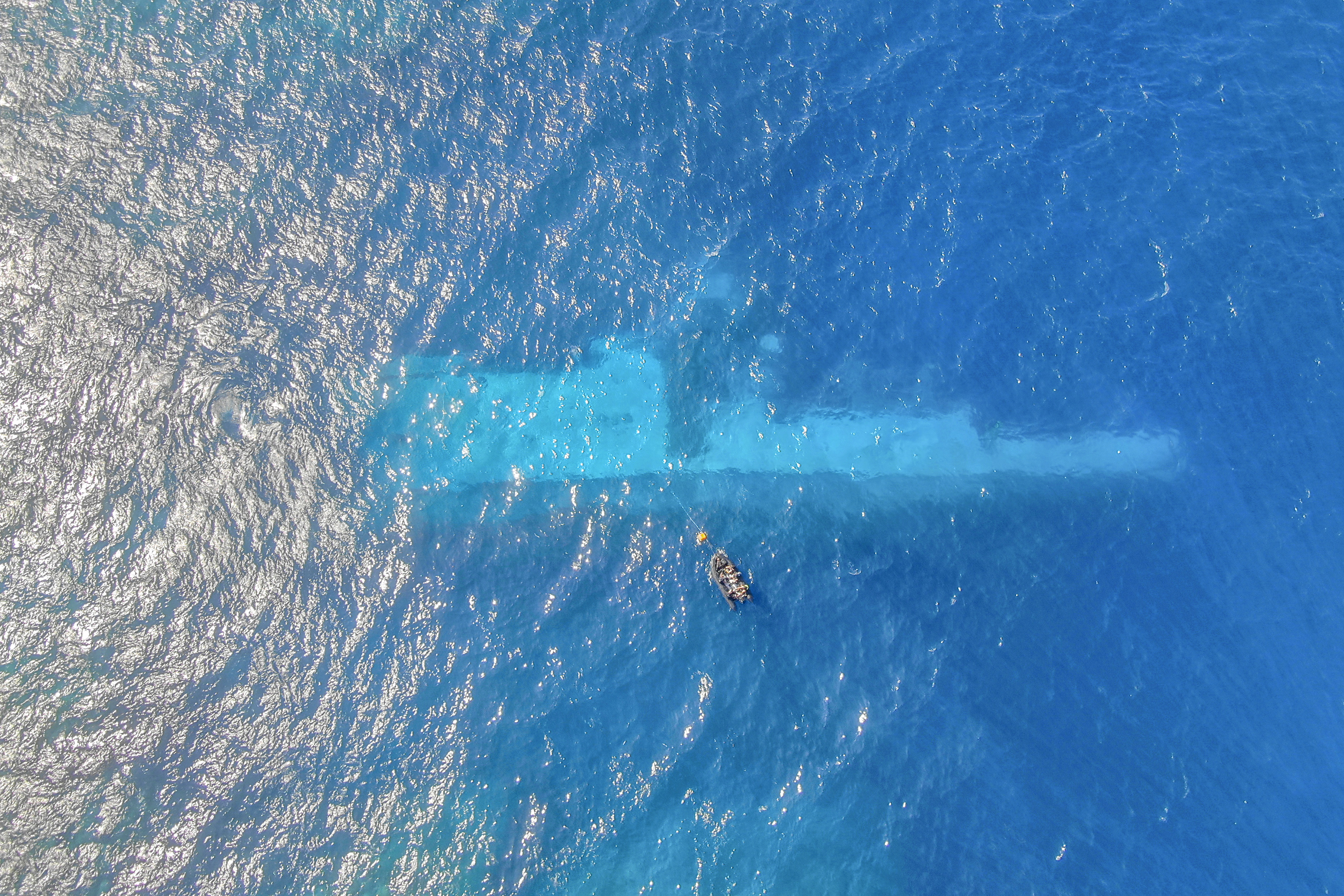 In this photo provided by the New Zealand Defence Force, divers survey the area around HMNZS Manawanui on the southern coast of Upulo, Samoa, after the Manawanui ran aground and sank on Oct. 6. (AC Jese Somerville/New Zealand Defence Force via AP)