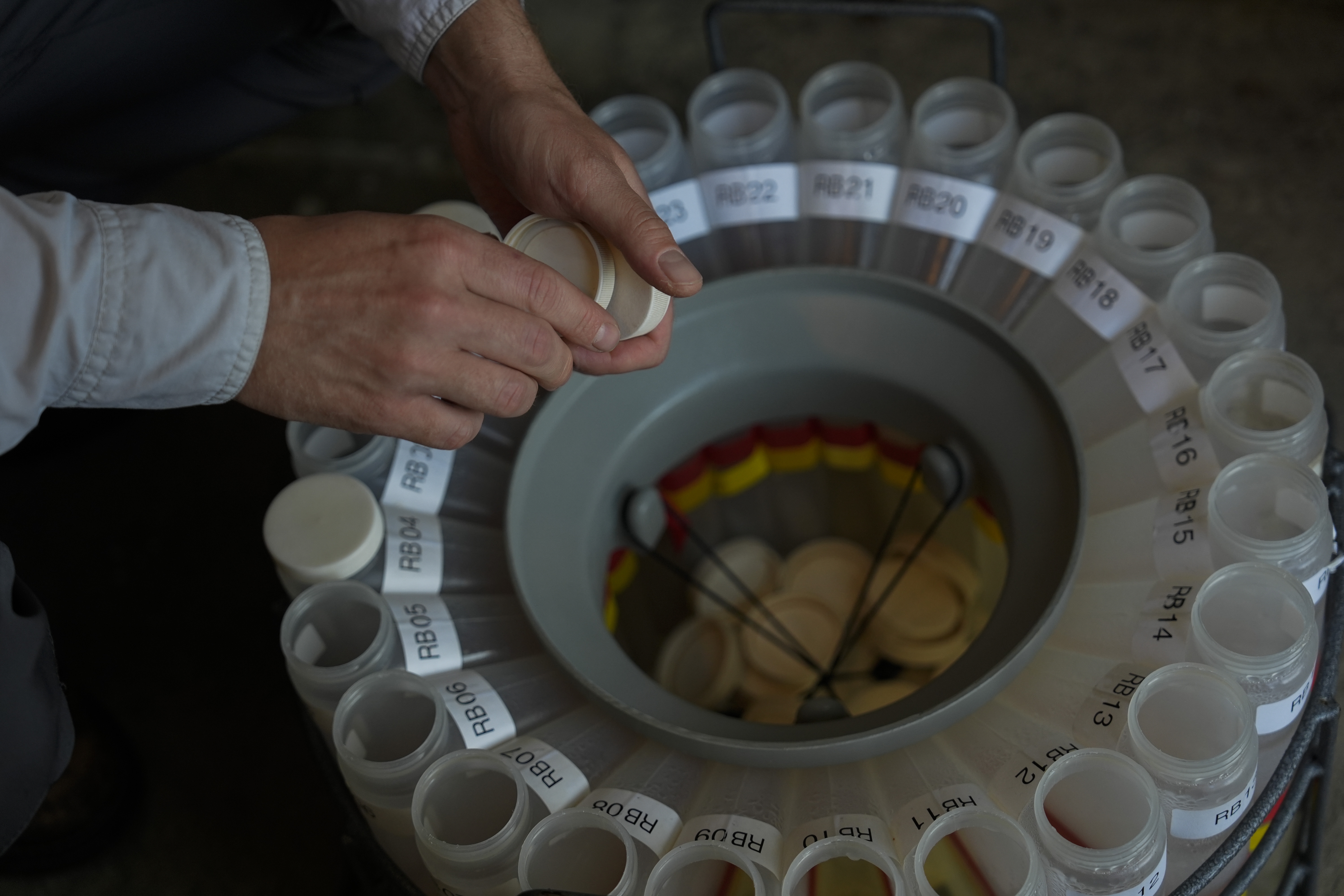 Jake Boehler, field manager at the National Center for Water Quality Research, collects water samples from a monitoring station, Monday, Aug. 26, 2024, in Woodville, Ohio. (AP Photo/Joshua A. Bickel)