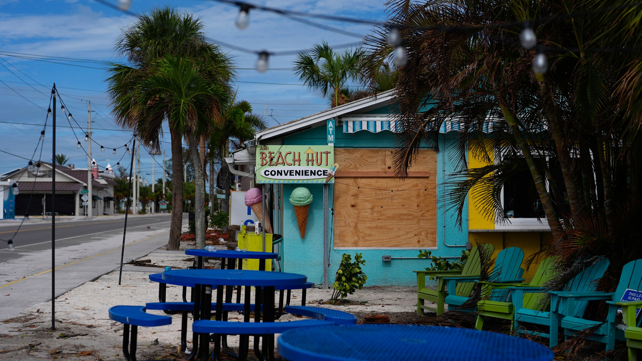 FILE - A boarded up business stands beside a deserted street in an evacuation zone, ahead of the arrival of Hurricane Milton, in Anna Maria, Fla., on Anna Maria Island, Oct. 8, 2024. (AP Photo/Rebecca Blackwell, File)